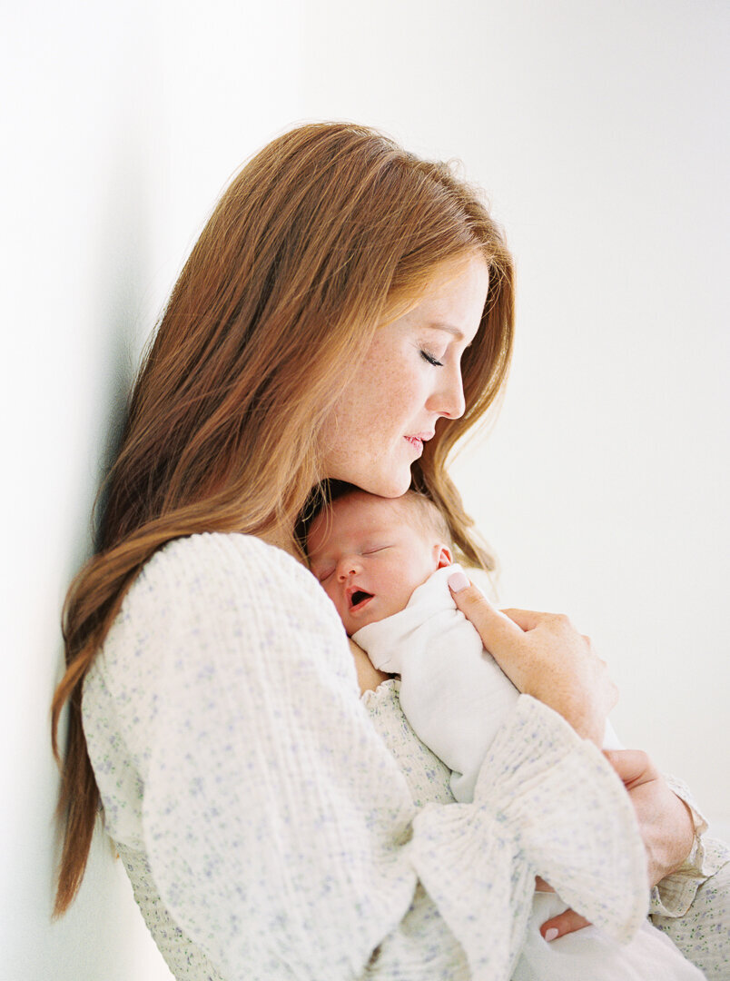 Redheaded mom holding newborn baby