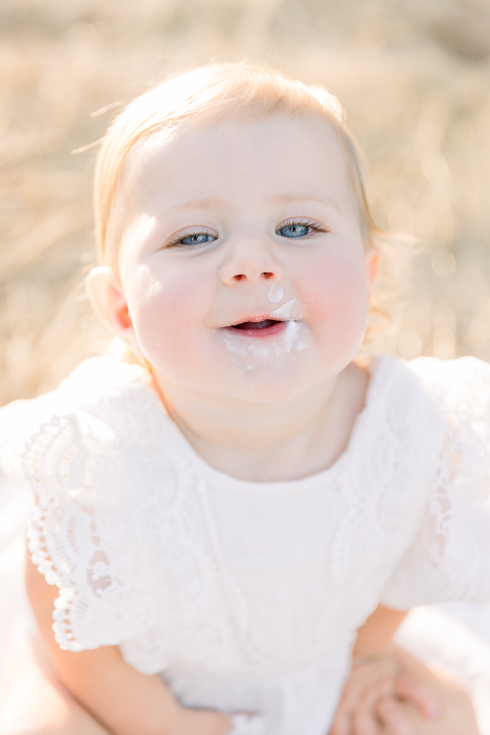 One year old baby with cake on face taken by Sacramento Newborn Photographer Kelsey Krall