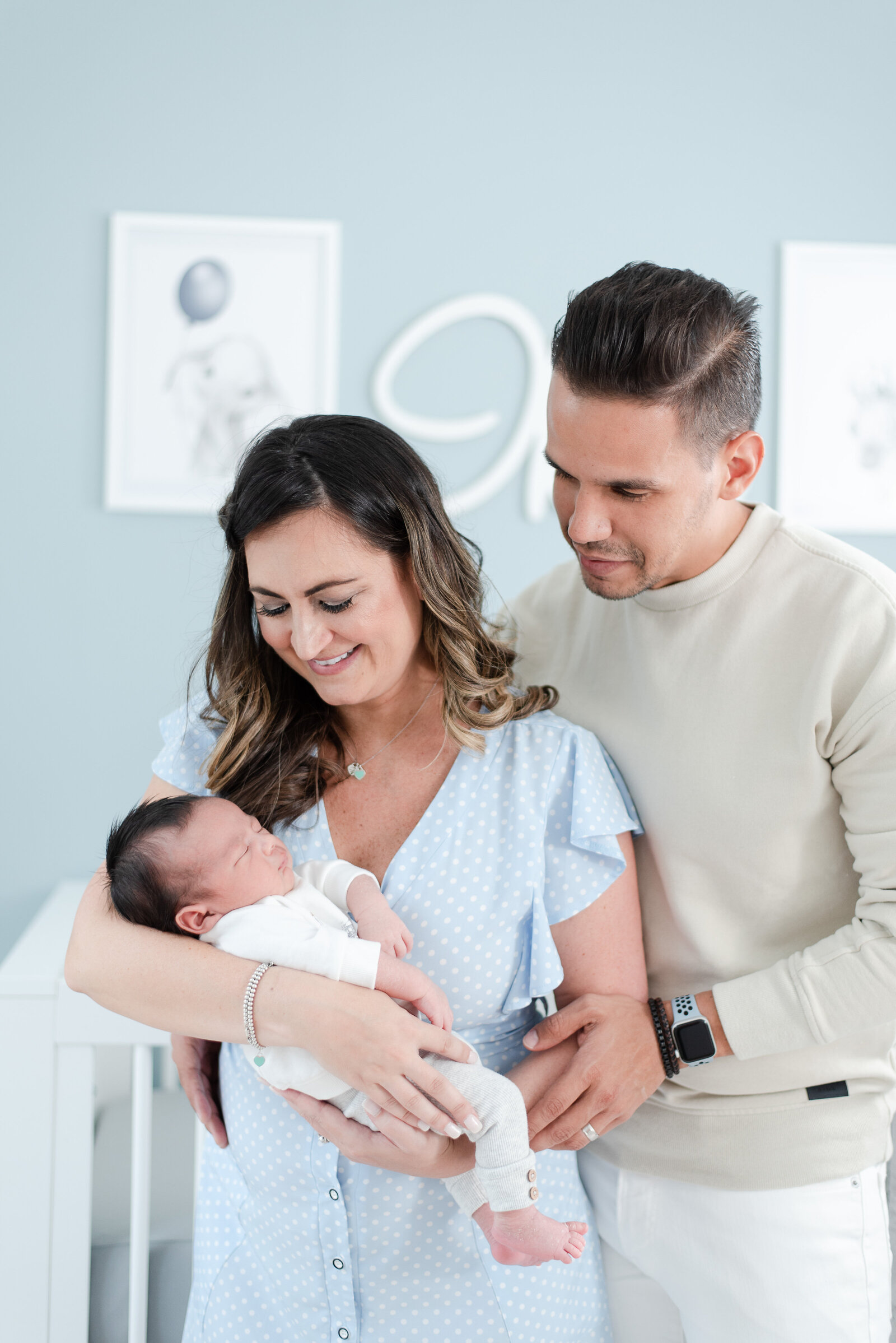 mom dad and newborn baby boy session in blue animal themed nursery in doral fl by Miami Lifestyle Photographers David and Meivys of MSP Photography