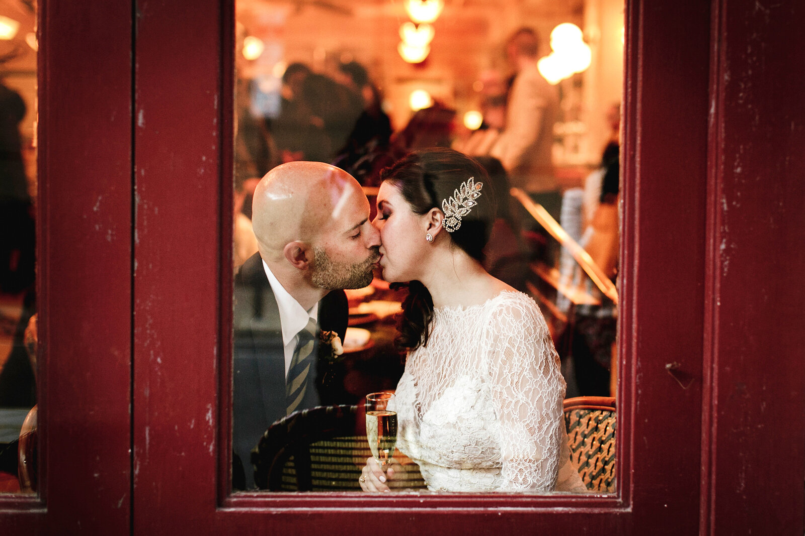 romantic couple kissing in restaurant window