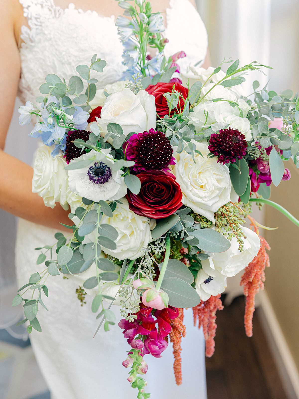 brides wedding bouquet with white and red roses eucalyptus and pink sprays