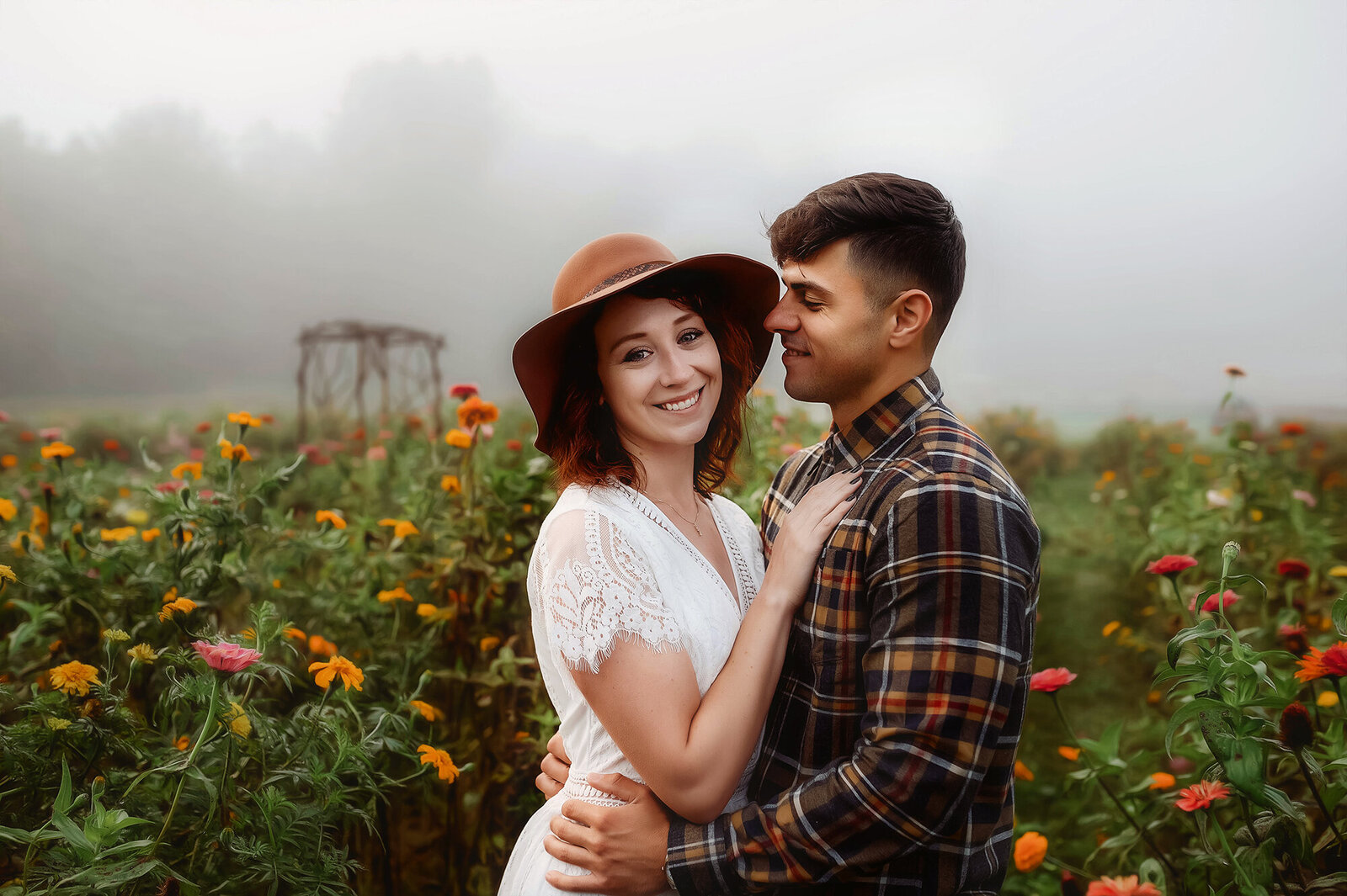 A couple poses for Engagement Photos in a field of flowers in Asheville, NC.