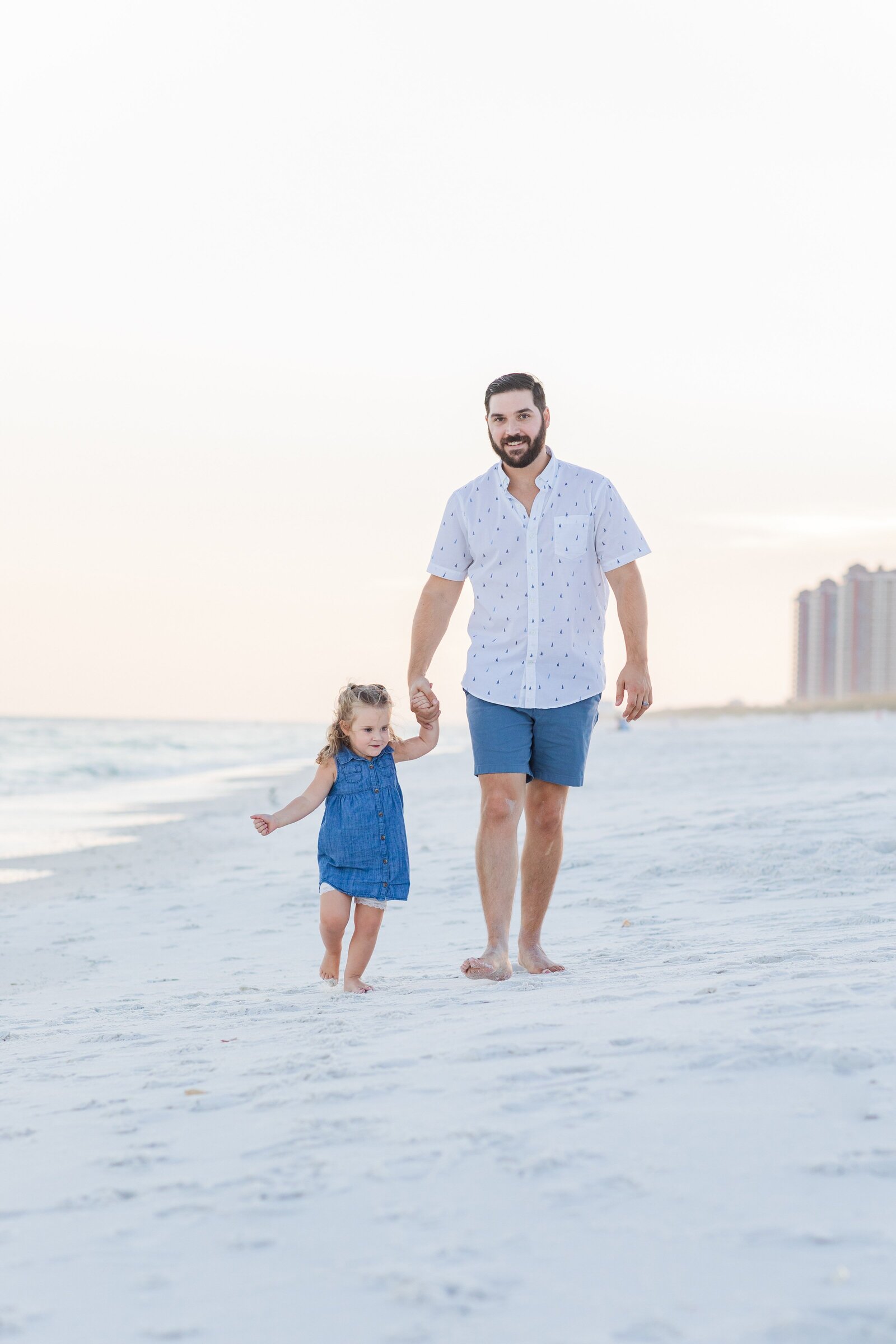 Father and Daughter walking down Pensacola Beach