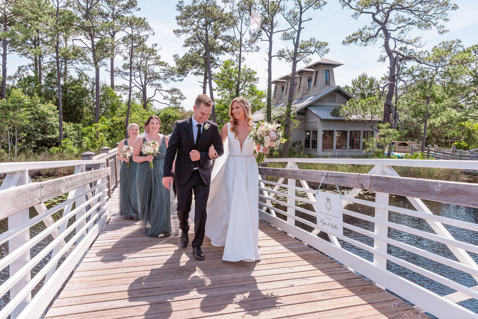 WaterColor wedding planner walking across the bridge at the Lakehouse