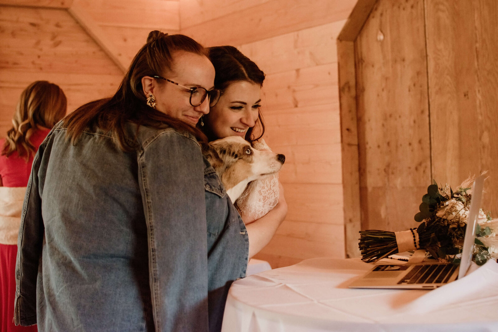 Bride and Best Dog chat with family online at wedding.