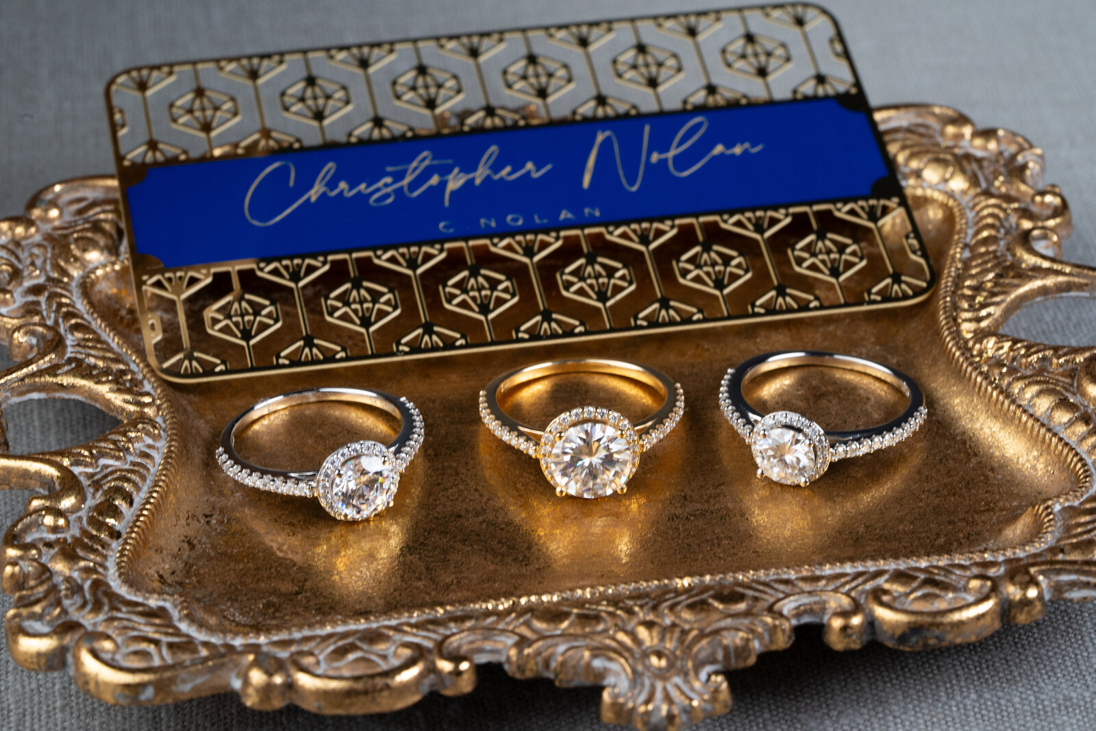 three diamond halos on rich gold tray