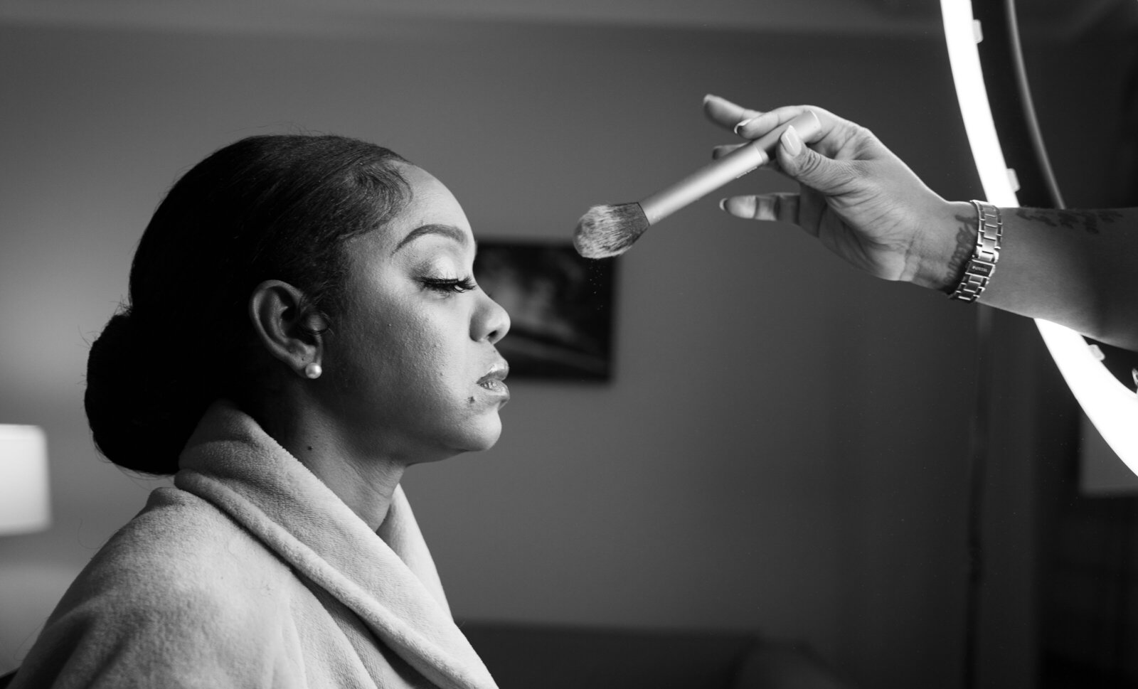 Bride getting makeup touch up for her wedding ceremony