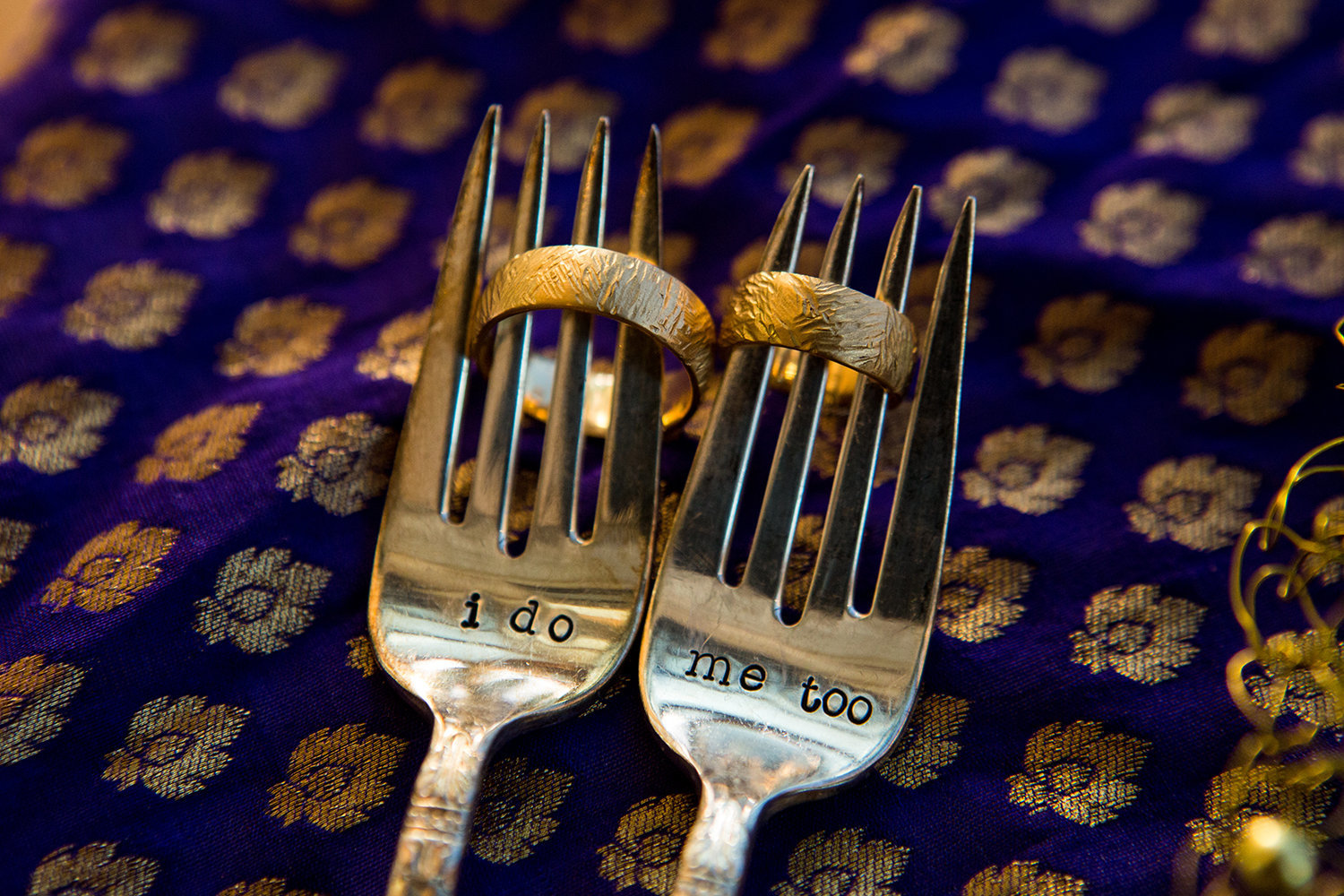 Creative ring detail photo using forks at an Indian wedding