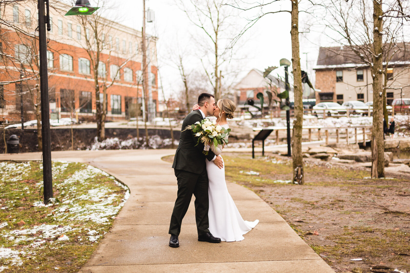 bride and groom kissing for portrait at winter ohio wedding