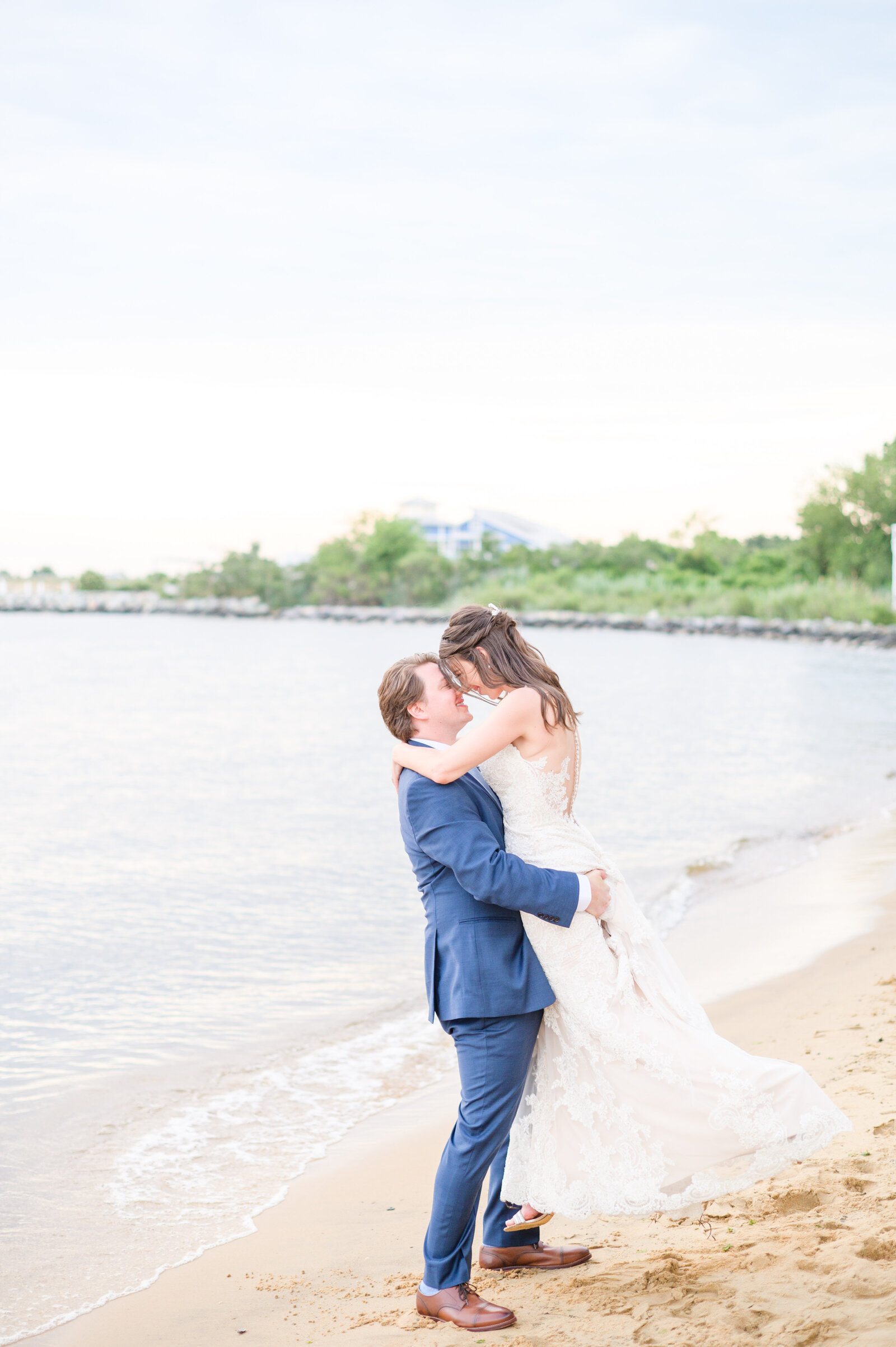 Couple embraces on the beach at sunset during Chesapeake Bay Beach Club Wedding photgraphed by baltimore wedding photographer Cait Kramer