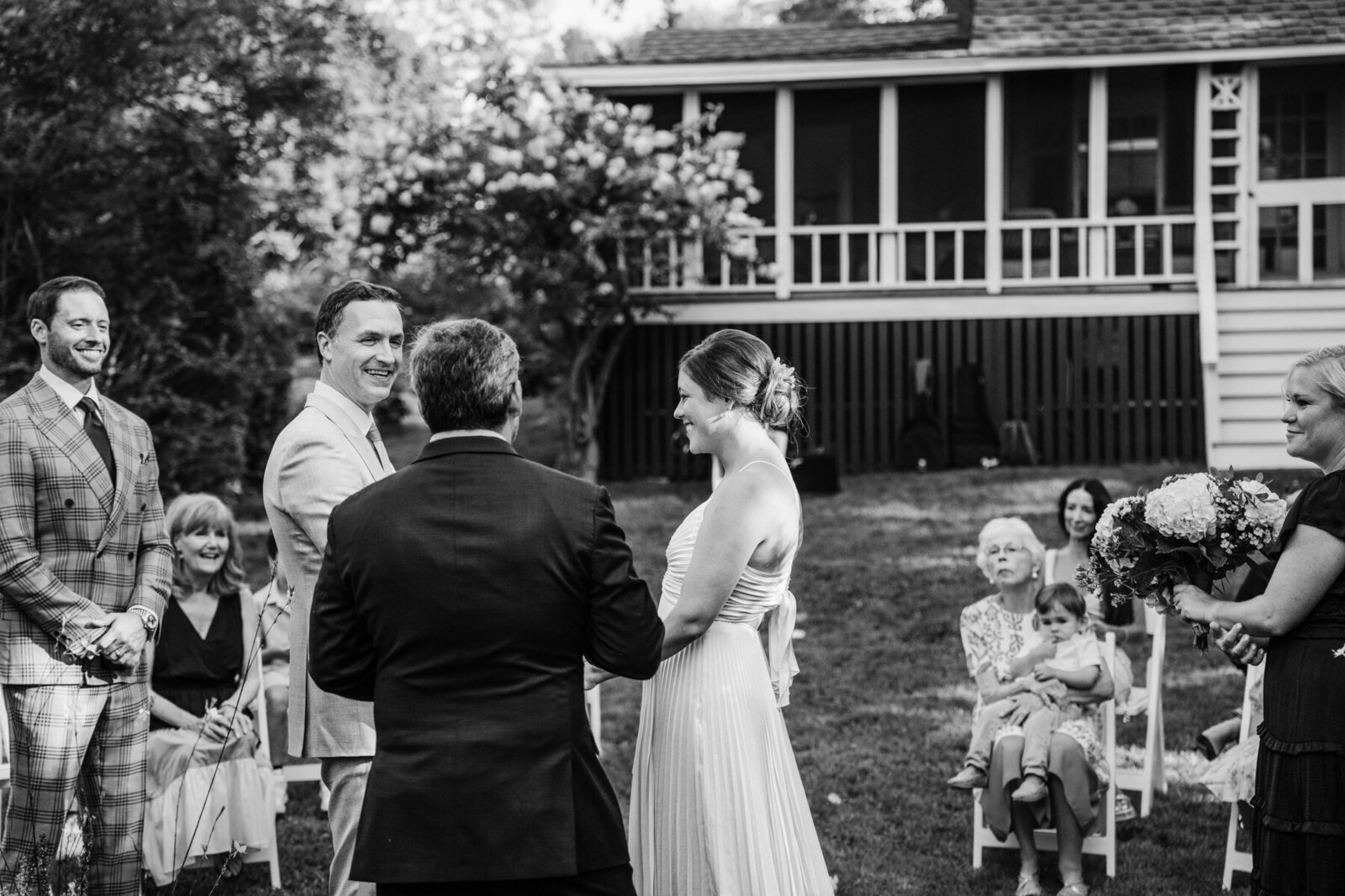 black and white portrait of a small wedding ceremony in a massachusetts backyard
