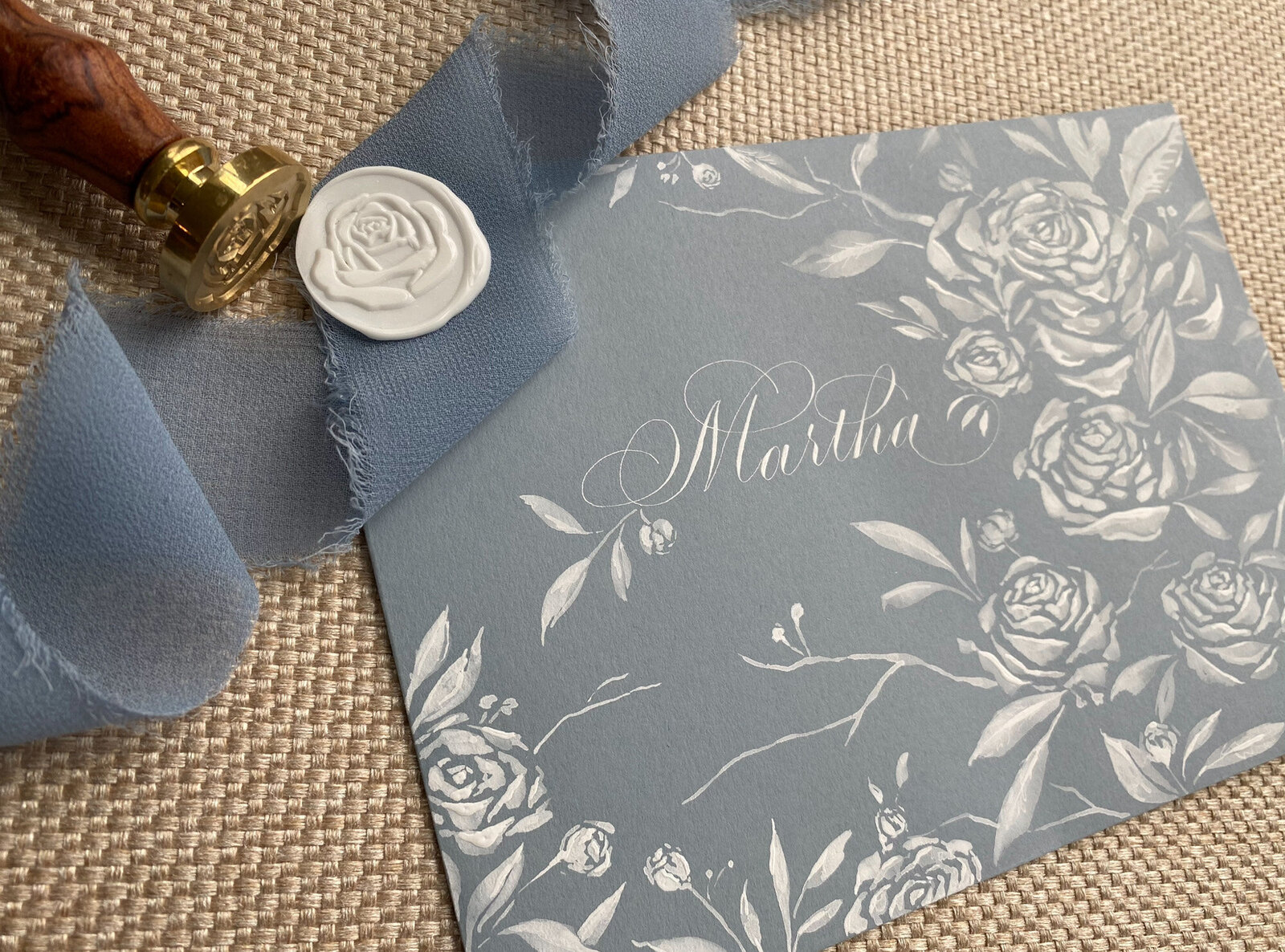Blue envelope with custom calligraphy with wax seal