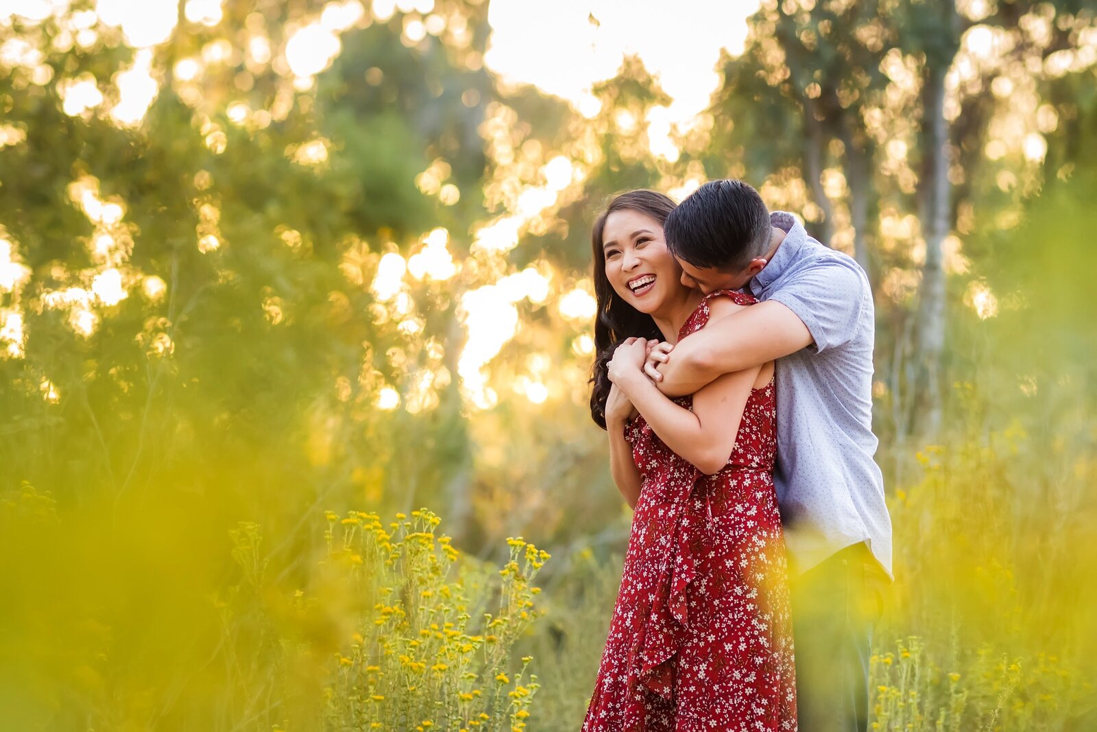 portrait of a couple snuggling in a flower field