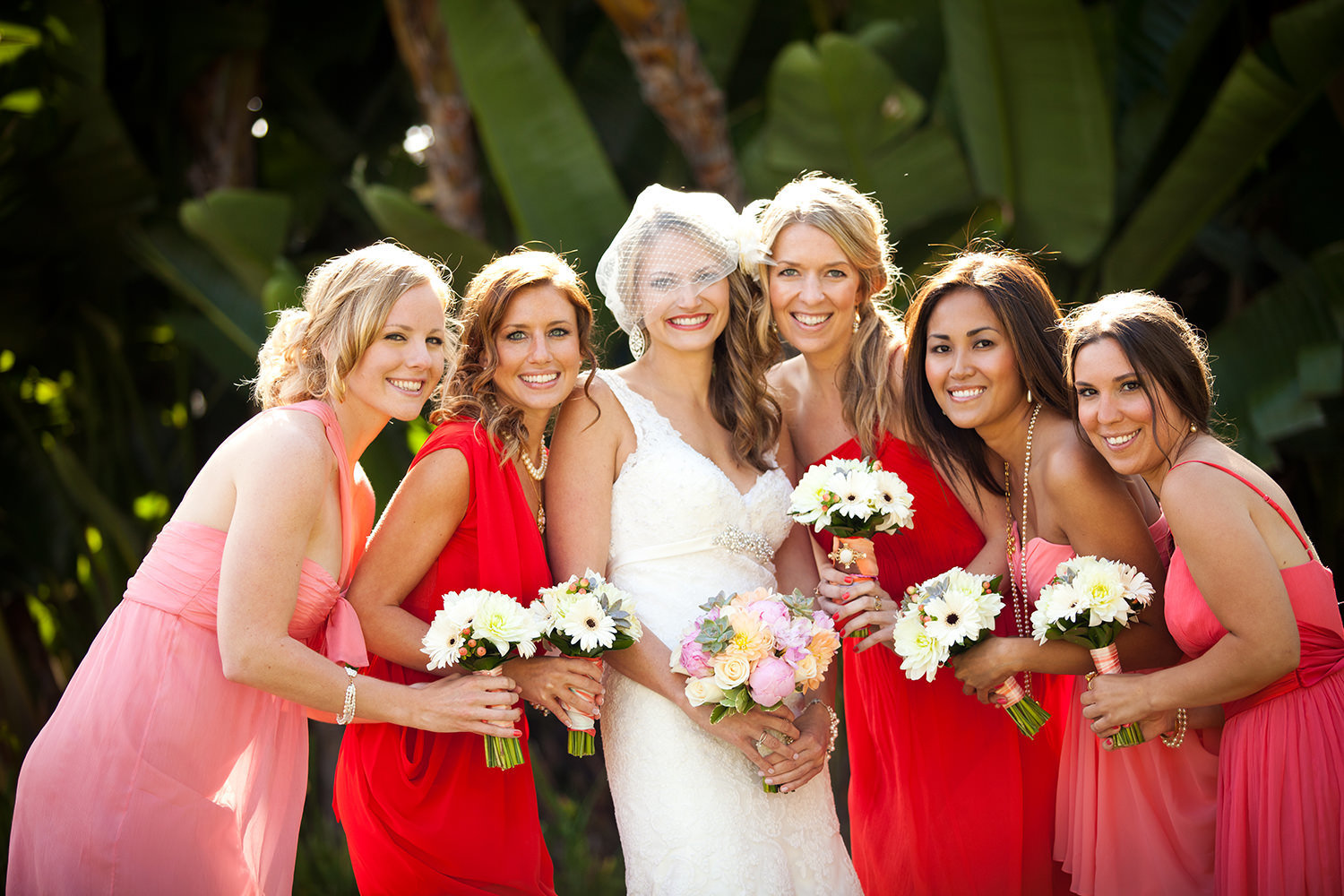 bride with bridesmaids at hilton mission bay with red and pink dresses