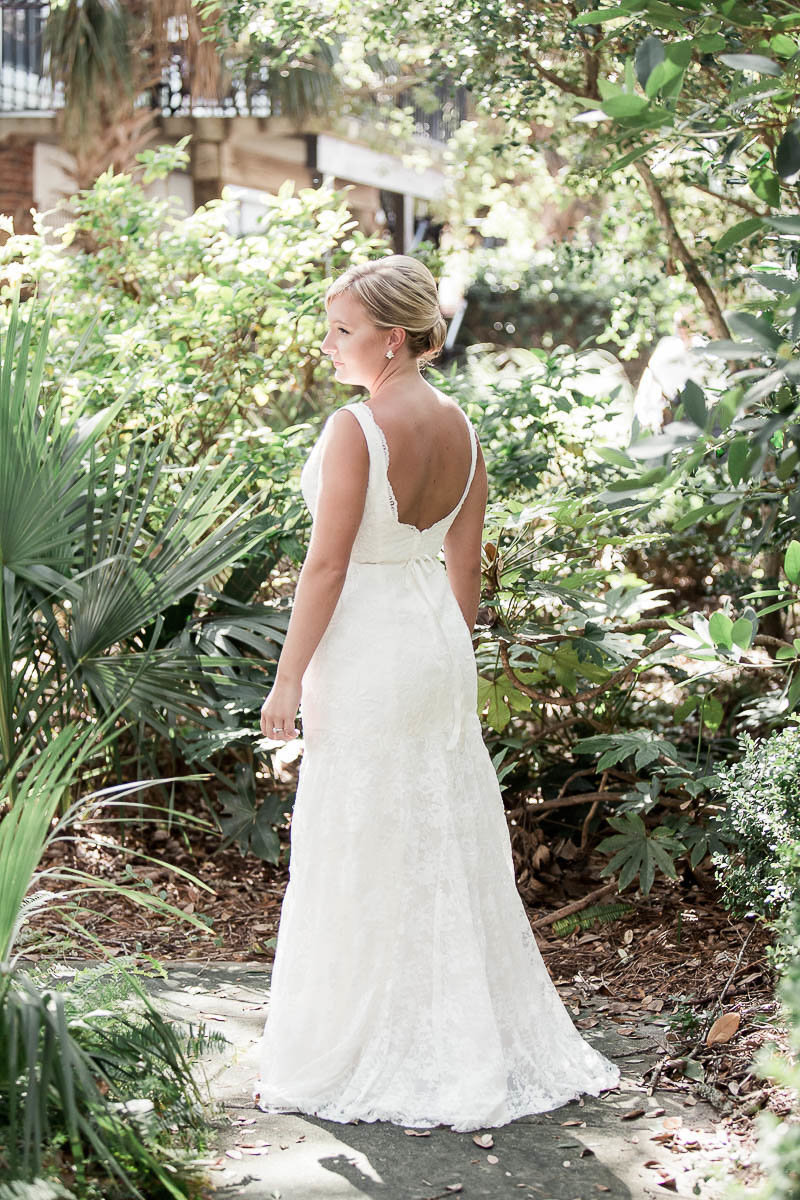 Bride stands among palm trees, Wild Dunes, Charleston, South Carolina