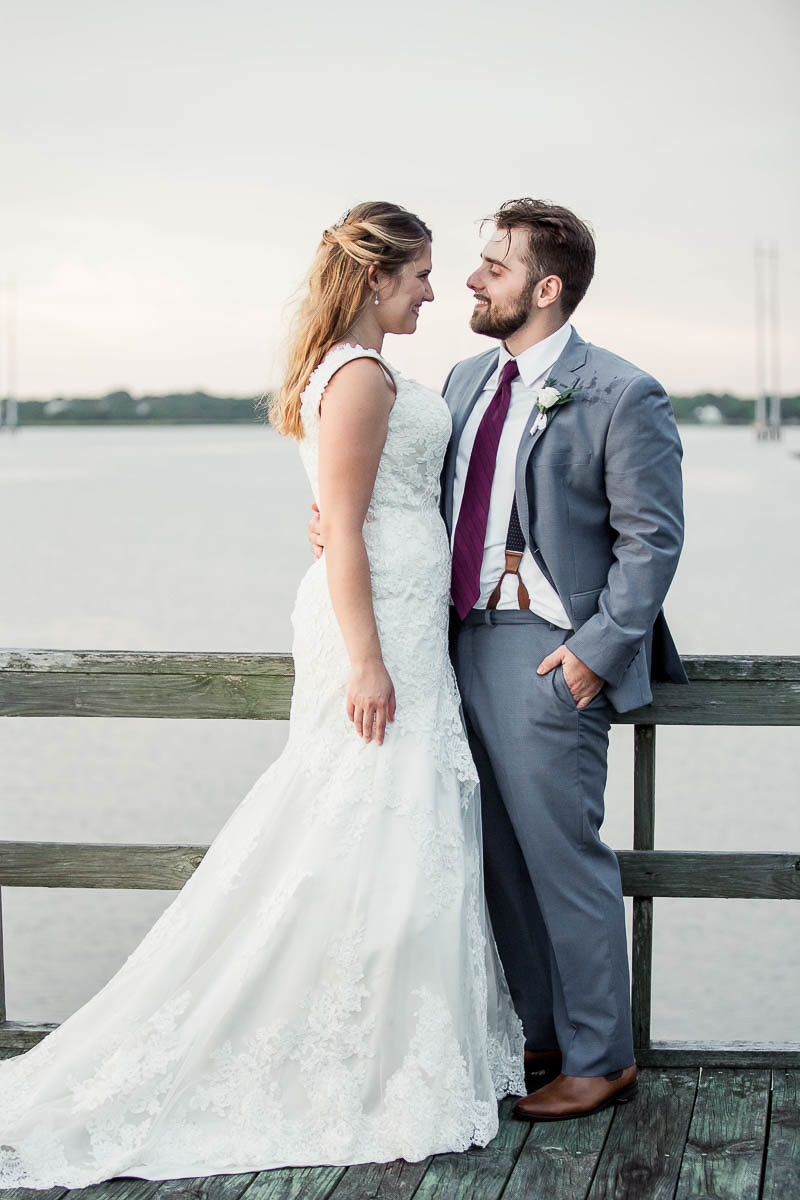 Bride and groom pose at sunset on the dock, The Island House, Charleston, South Carolina