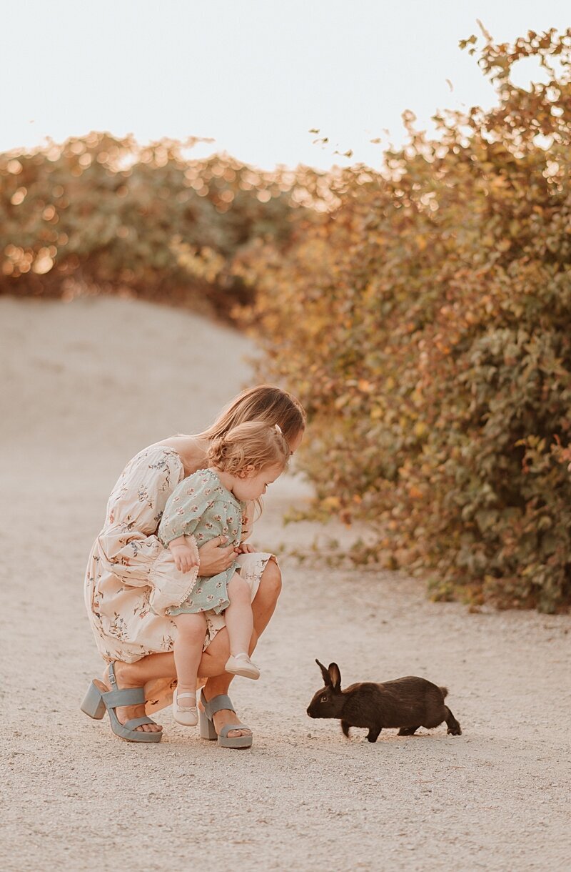 Mom and daughter encountering a bunny during their family photography session in Vancouver