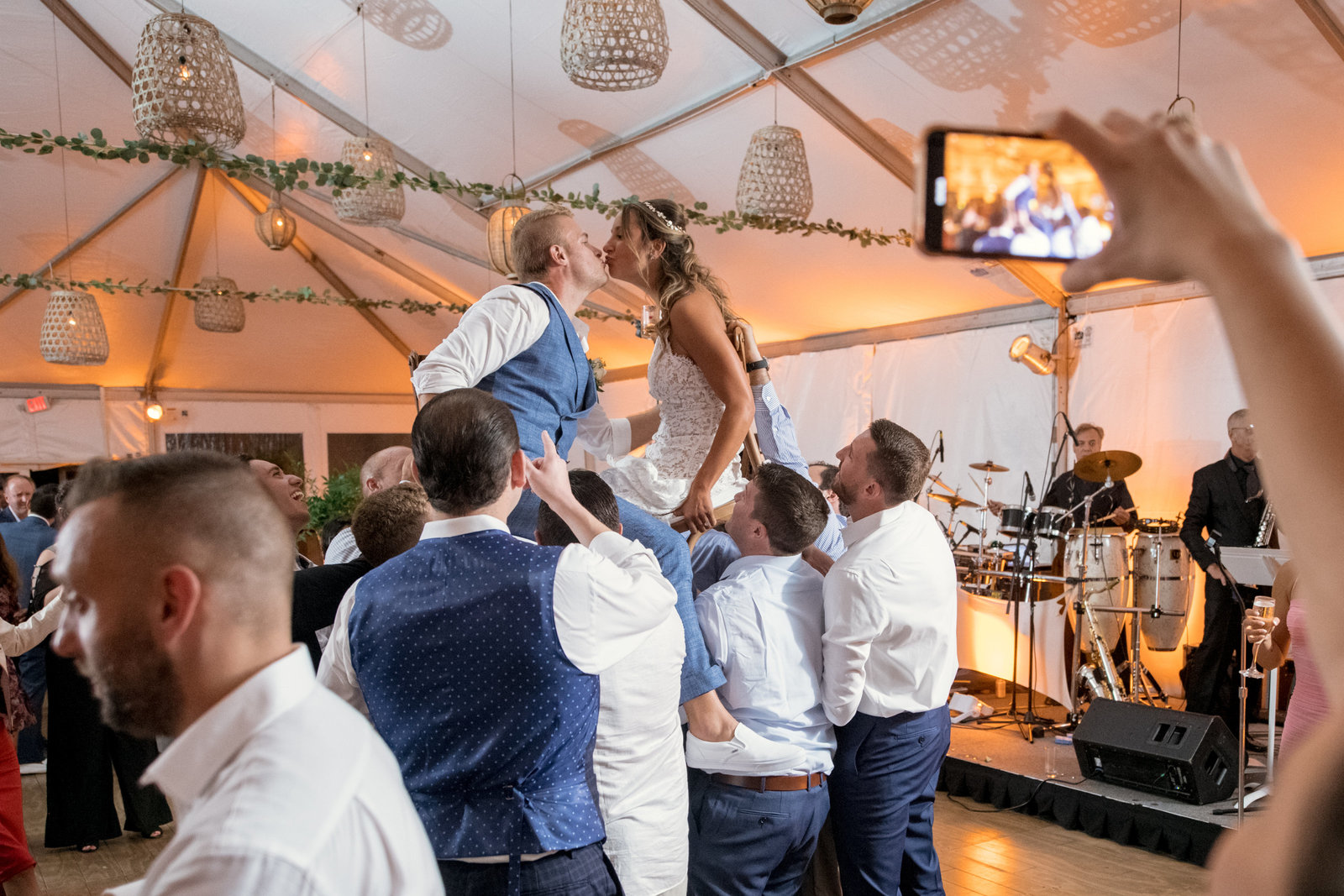 groomsmen holding up bride and groom for chair dance Gurneys Montauk Resort wedding