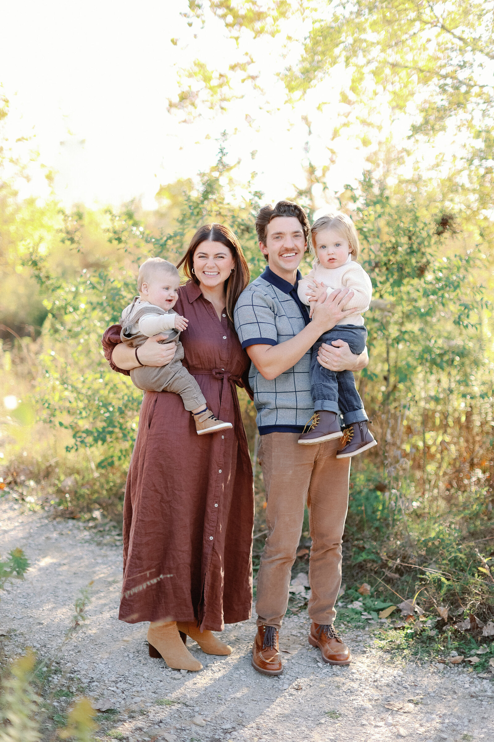 family smiling at the camera during fall mini sessions