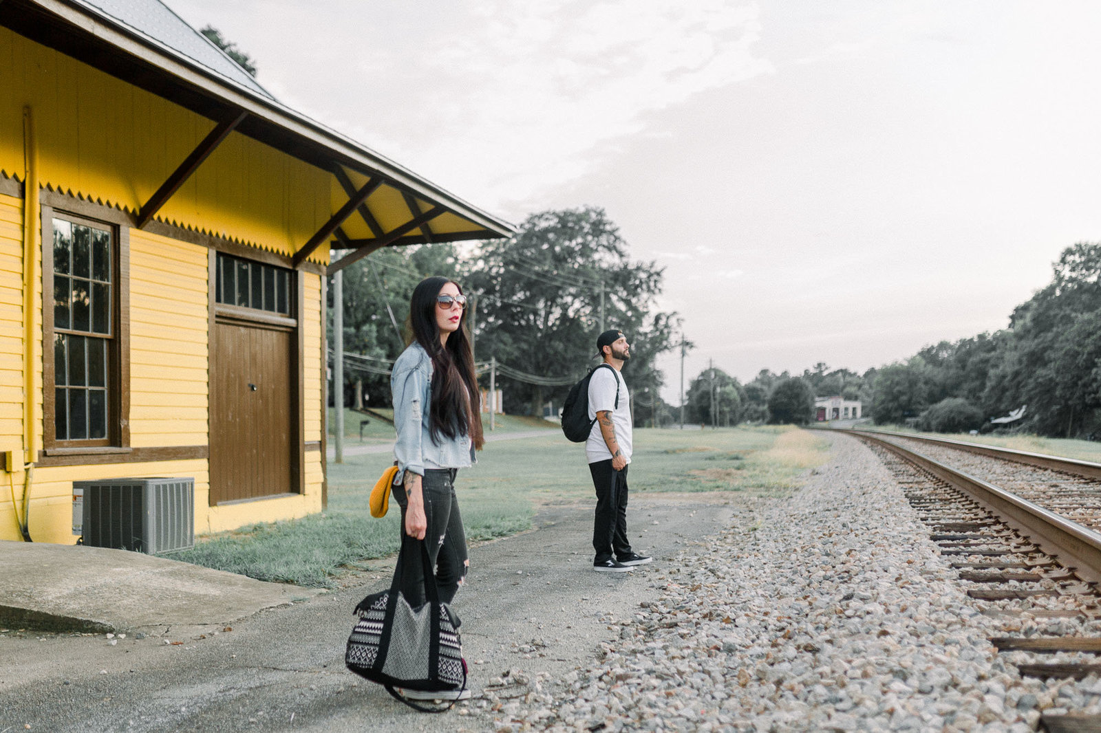 Couple waiting for the train captured by Staci Addison Photography