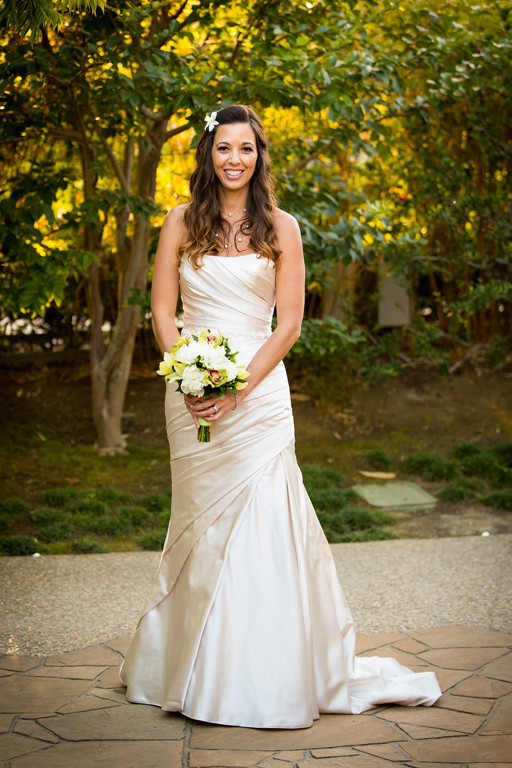 bride with white flowers smiling