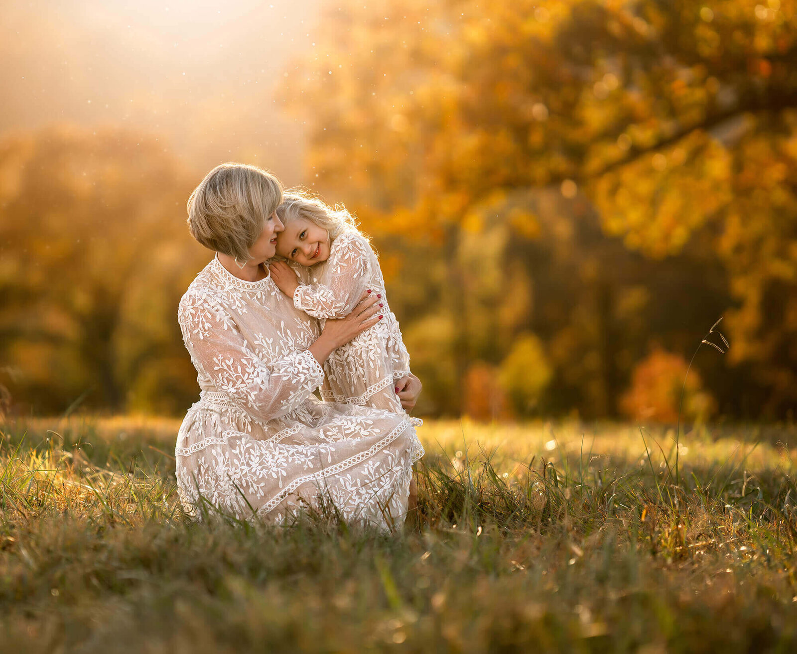 An Asheville Photographer photograph of a mom and daughter sunggling  at sunset