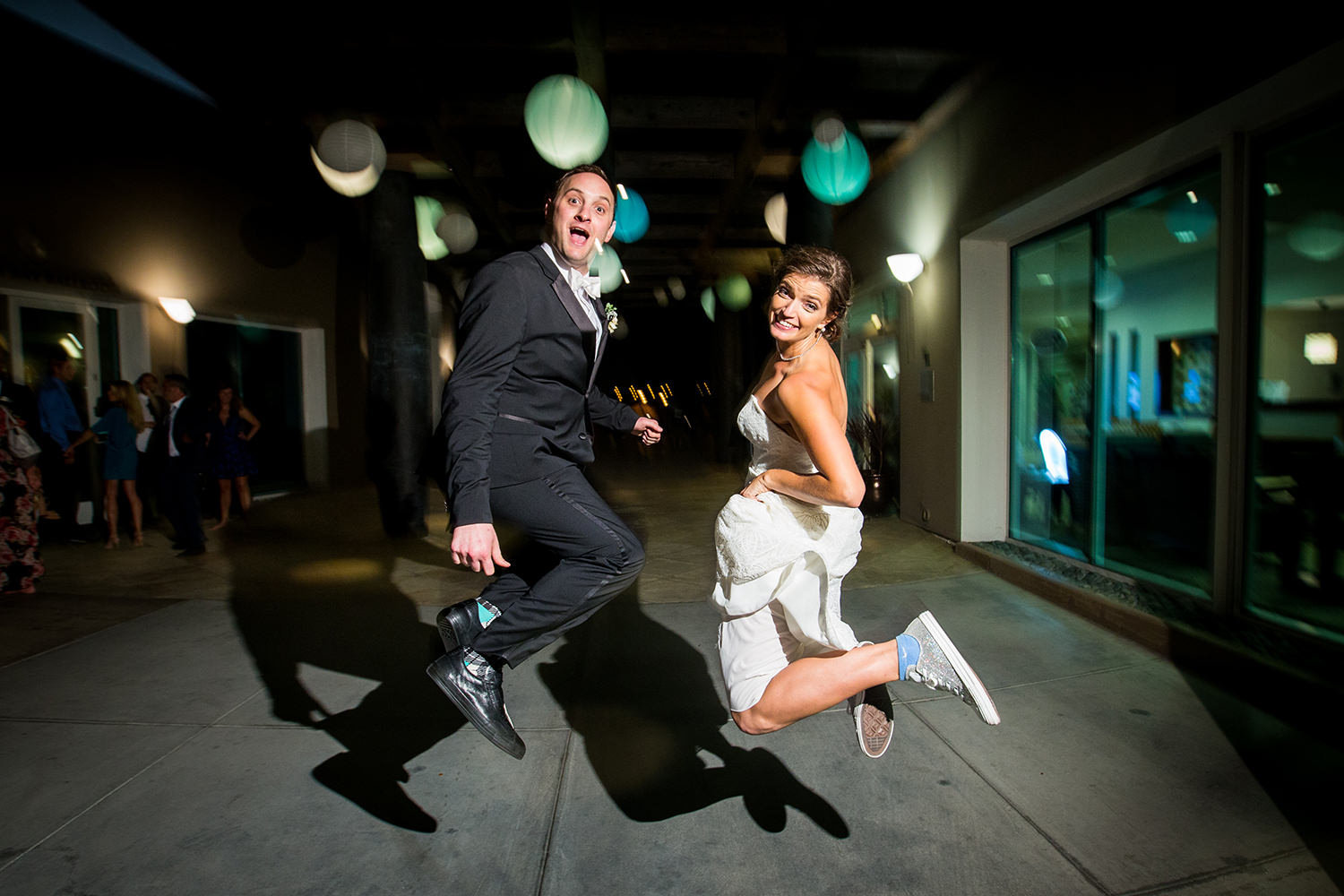 jumping night time shot with bride and groom