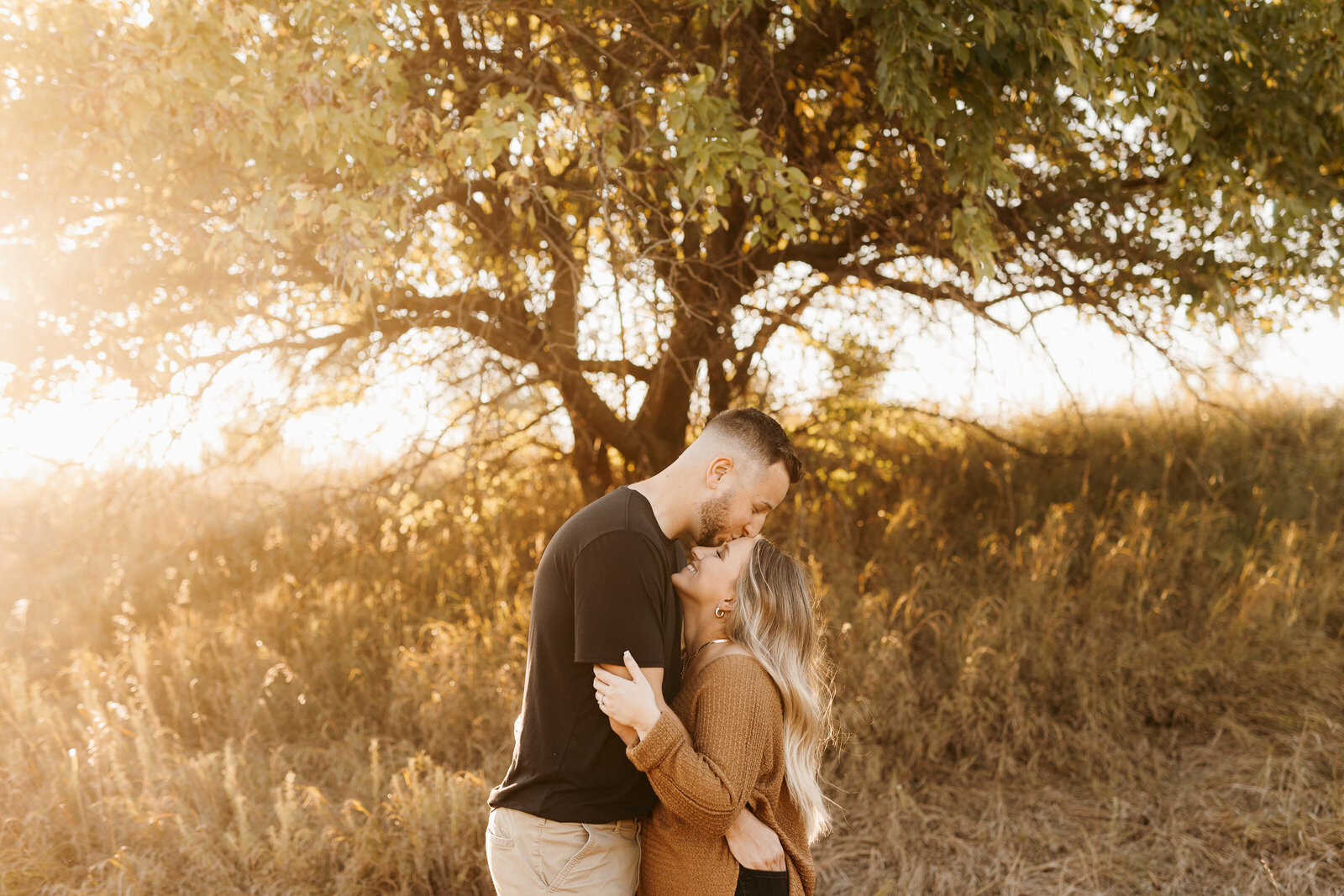Kissing Forehead pose during Fall Engagement Session at Golden Hour