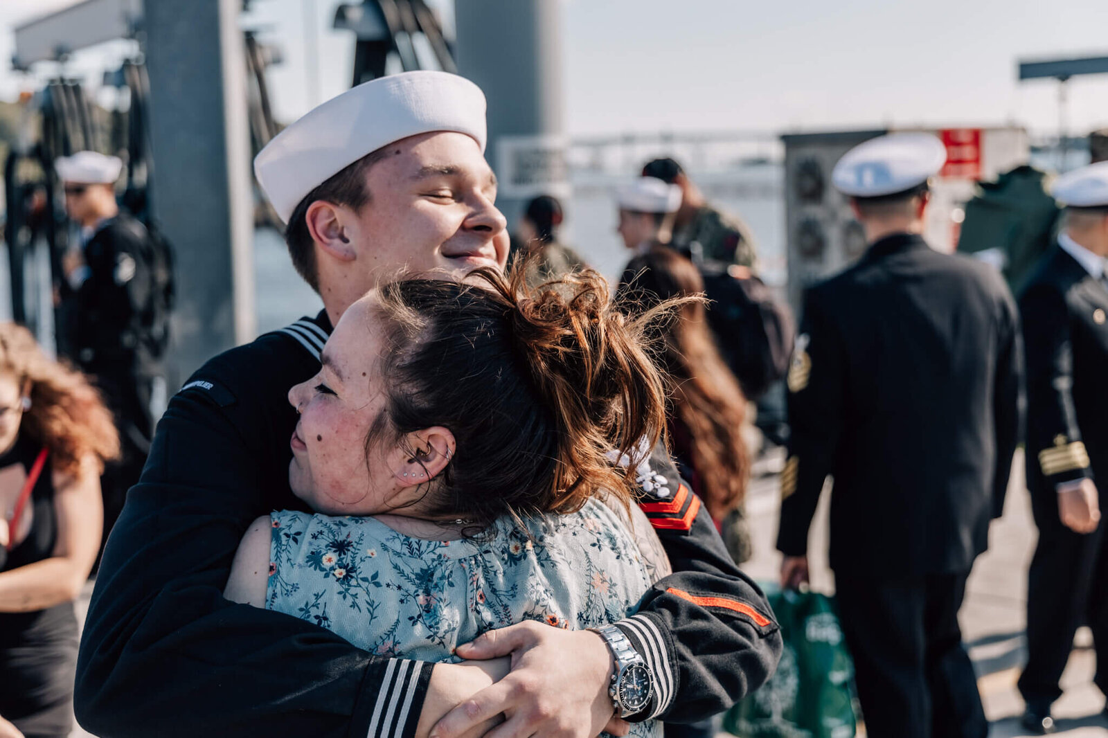 Sailor and woman embrace on pier during USS Montpelier Homecoming at SUBASE New London in Groton CT