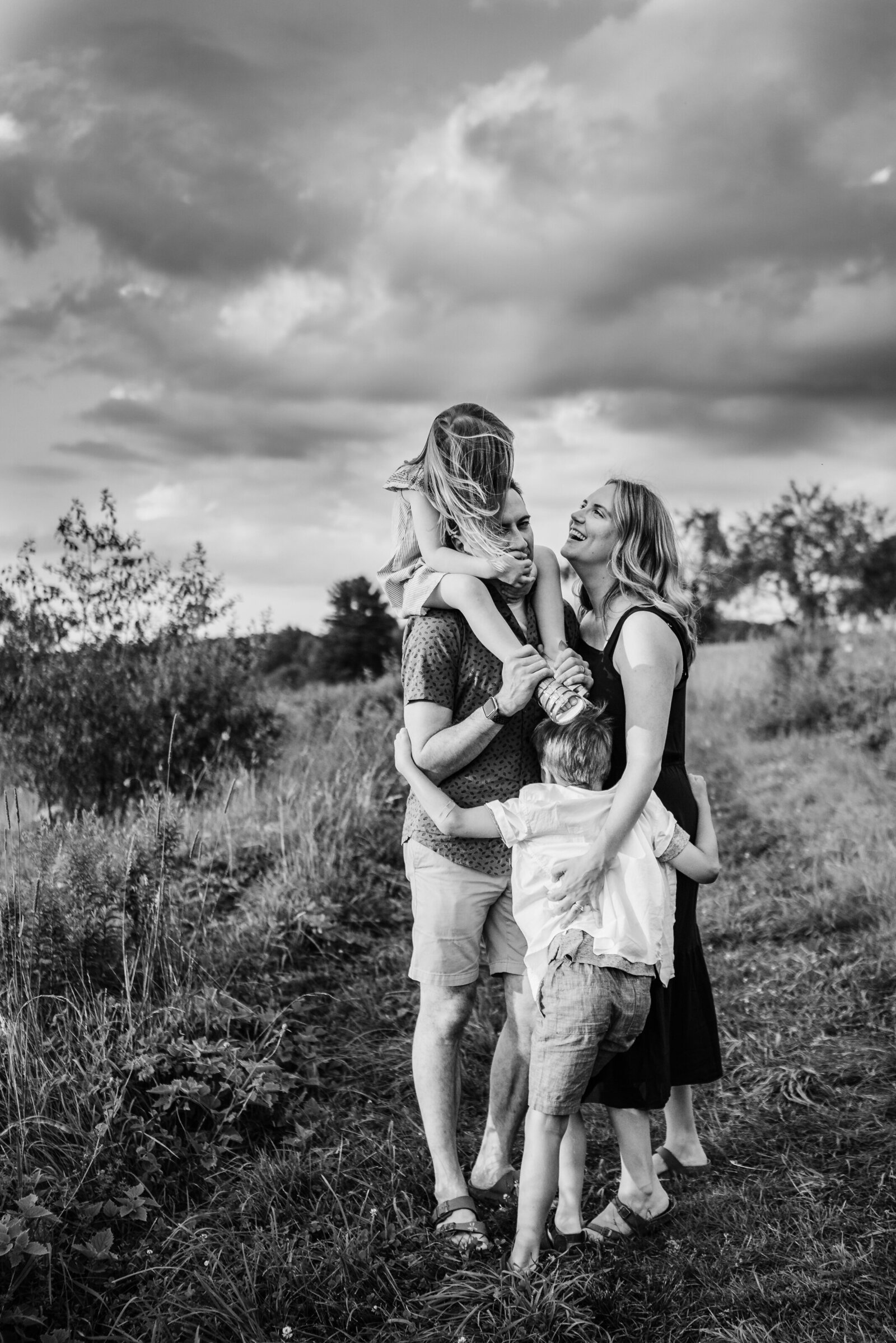 black and white image of family with clouds