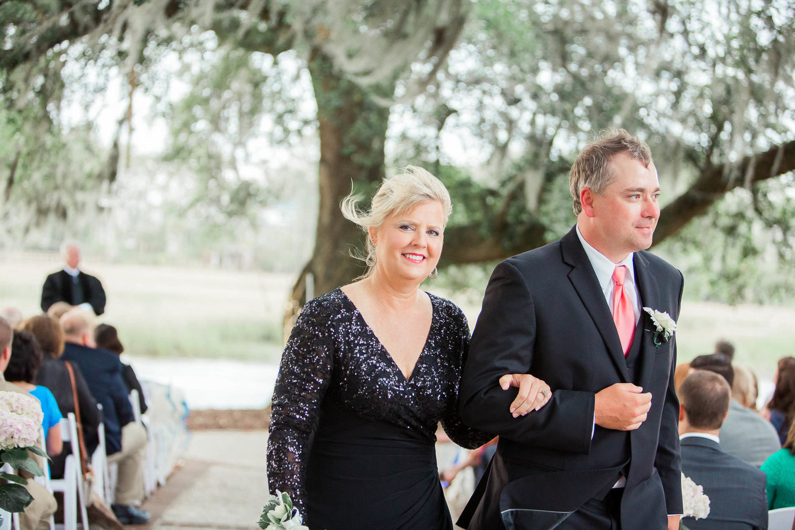 Mother is escorted down the aisle, Dunes West Golf and River Club, Mt Pleasant, South Carolina. Kate Timbers Photography.