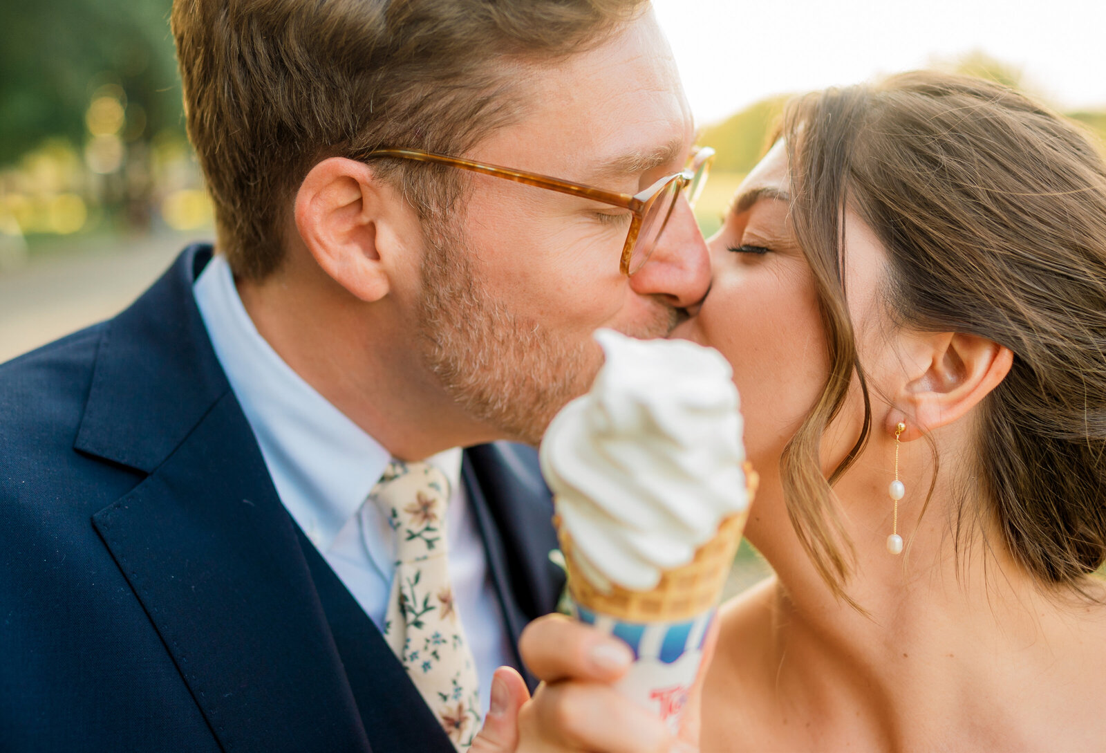 Florida wedding eating ice cream post ceremony kissing in the sunlight