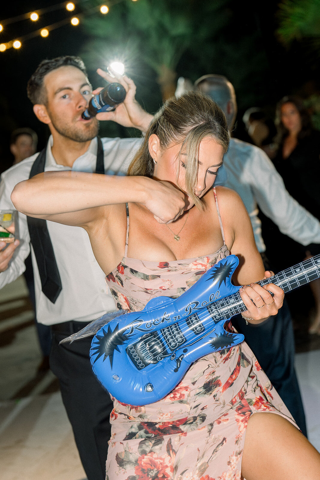 Editorial film image of bride dancing in vibrant blue dress during a luxury Los Angeles wedding reception.