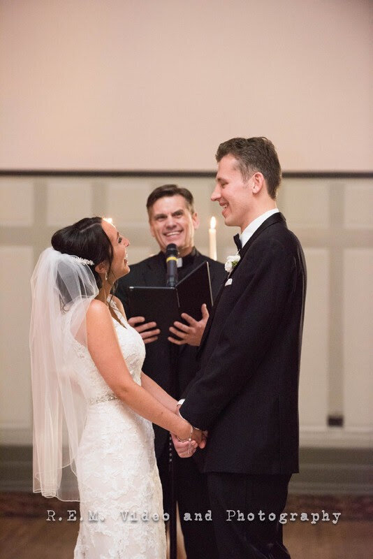 Bride and groom smile at each other during wedding ceremony