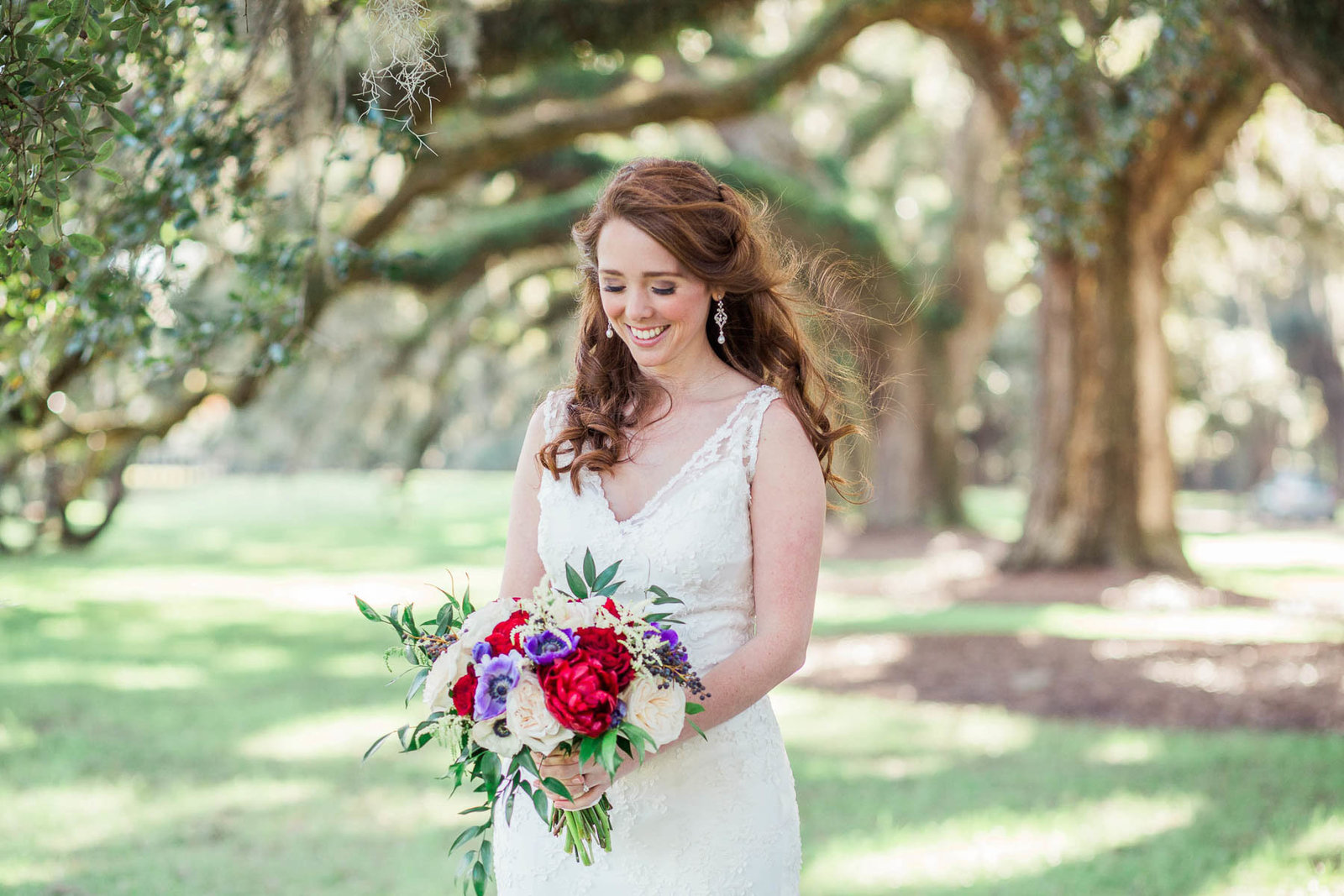 Bride stands under avenue of oaks, Boone Hall Plantation, Charleston, South Carolina