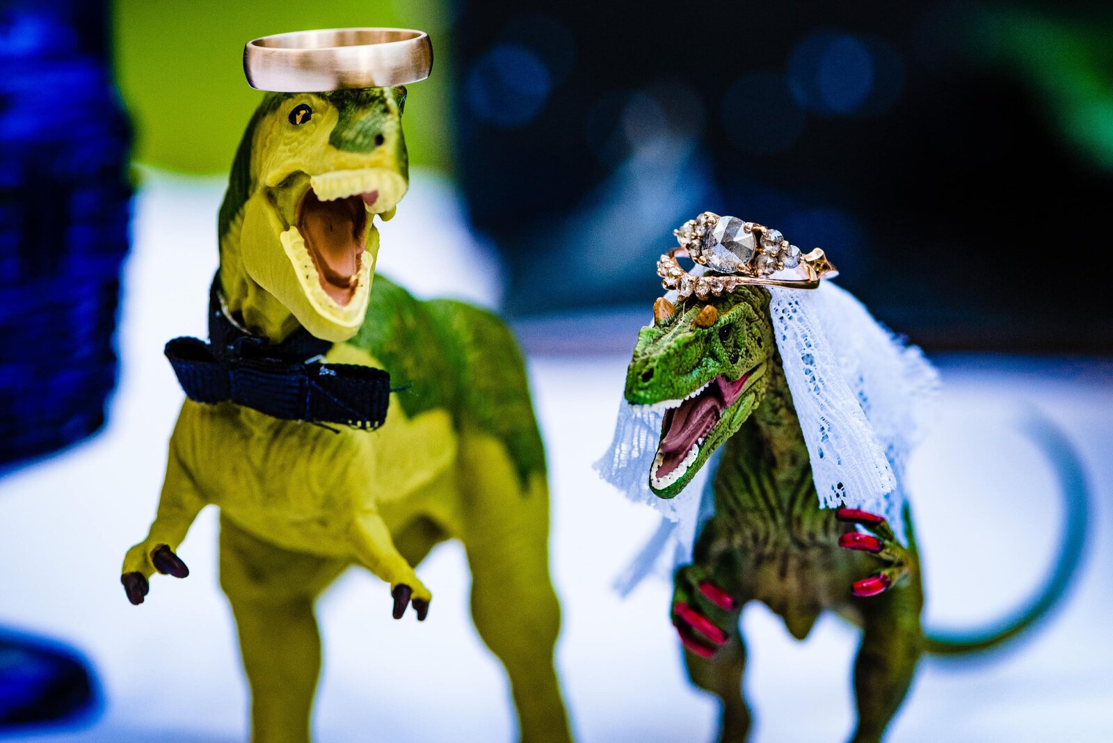 wedding rings set on top of toy dinosaurs look like crowns