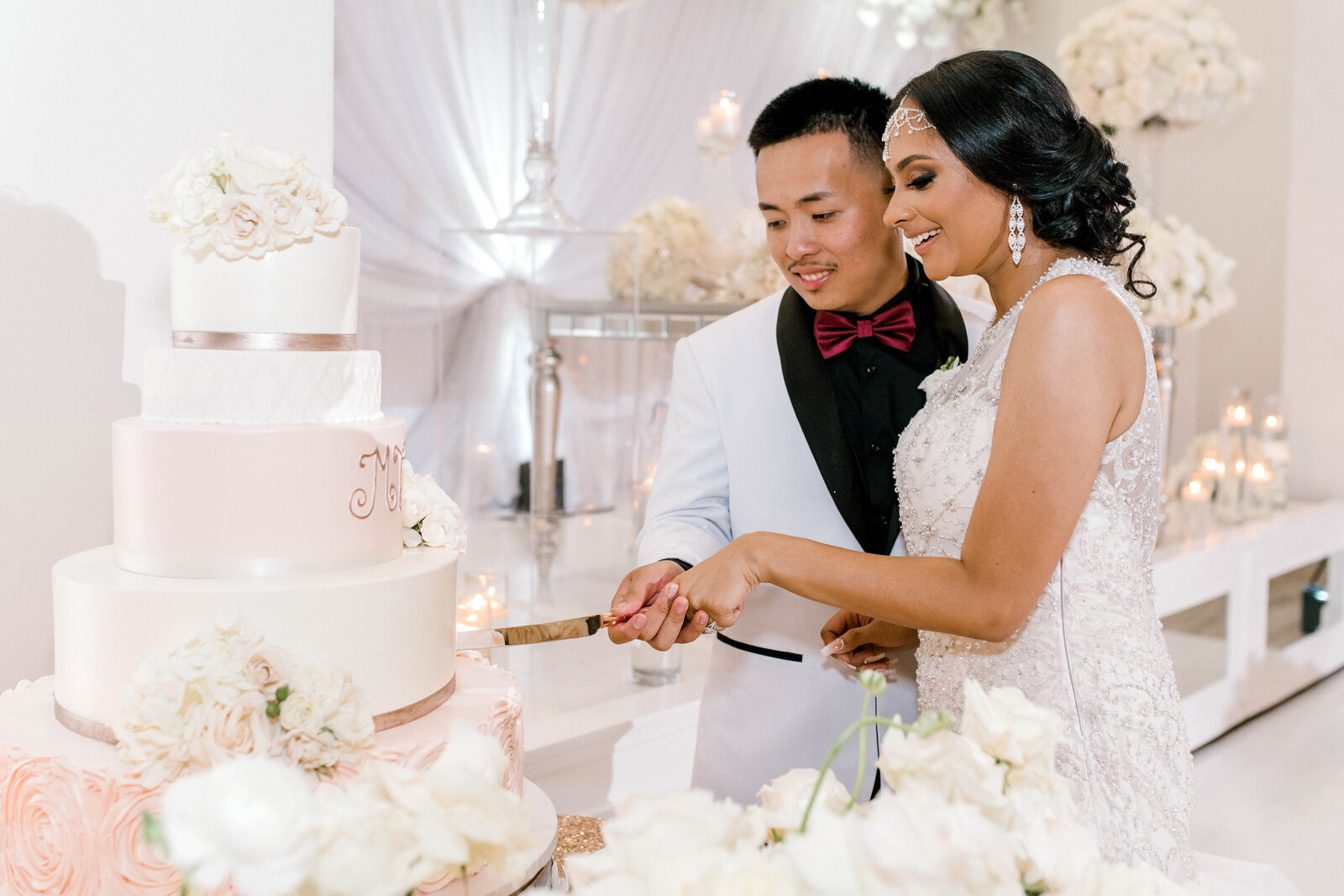 Bride and groom cutting their wedding cake together