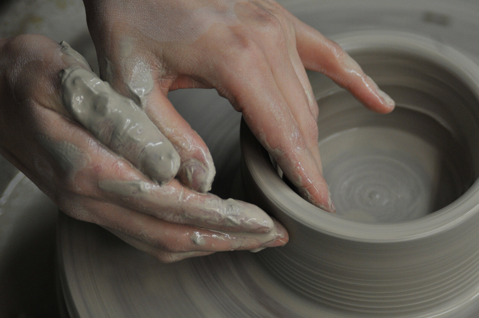 liz allen hands in clay on pottery wheel