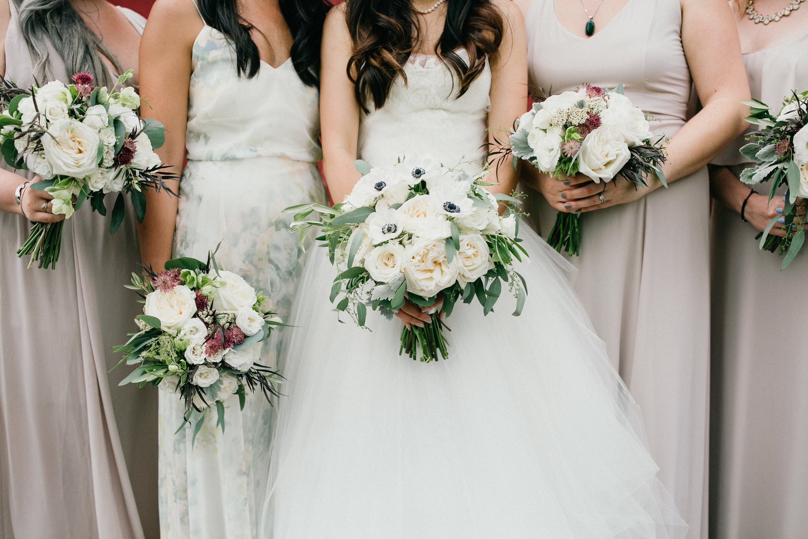Bride and her bridesmaids compliment each other with their natural hued dresses.