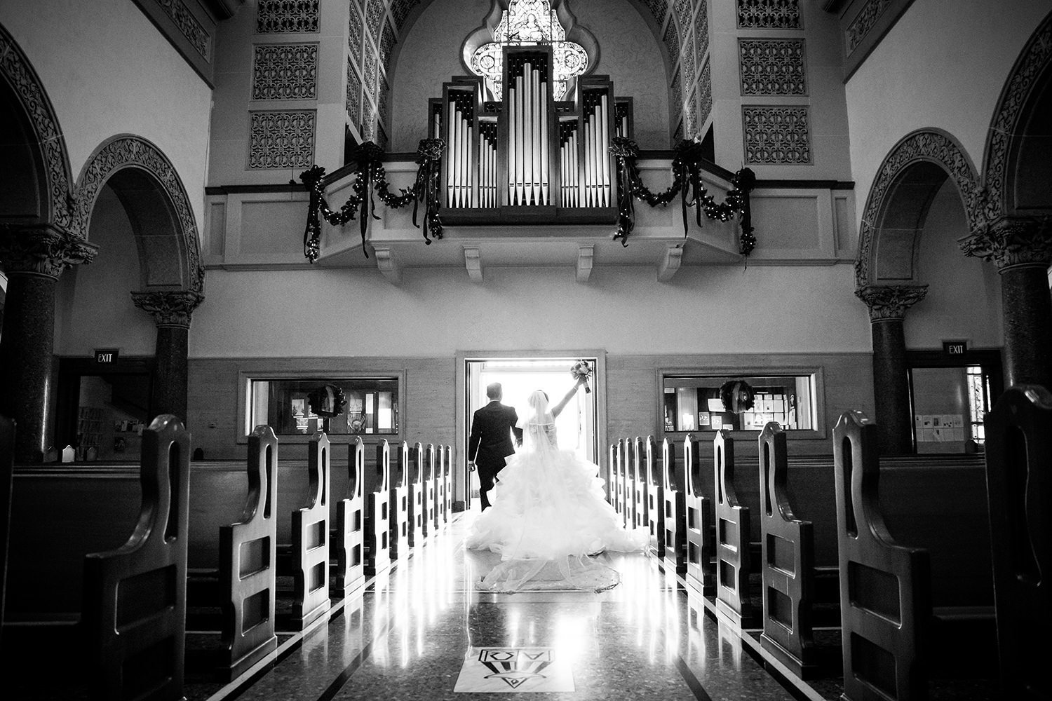 couple walking out of the immaculata of their i do's