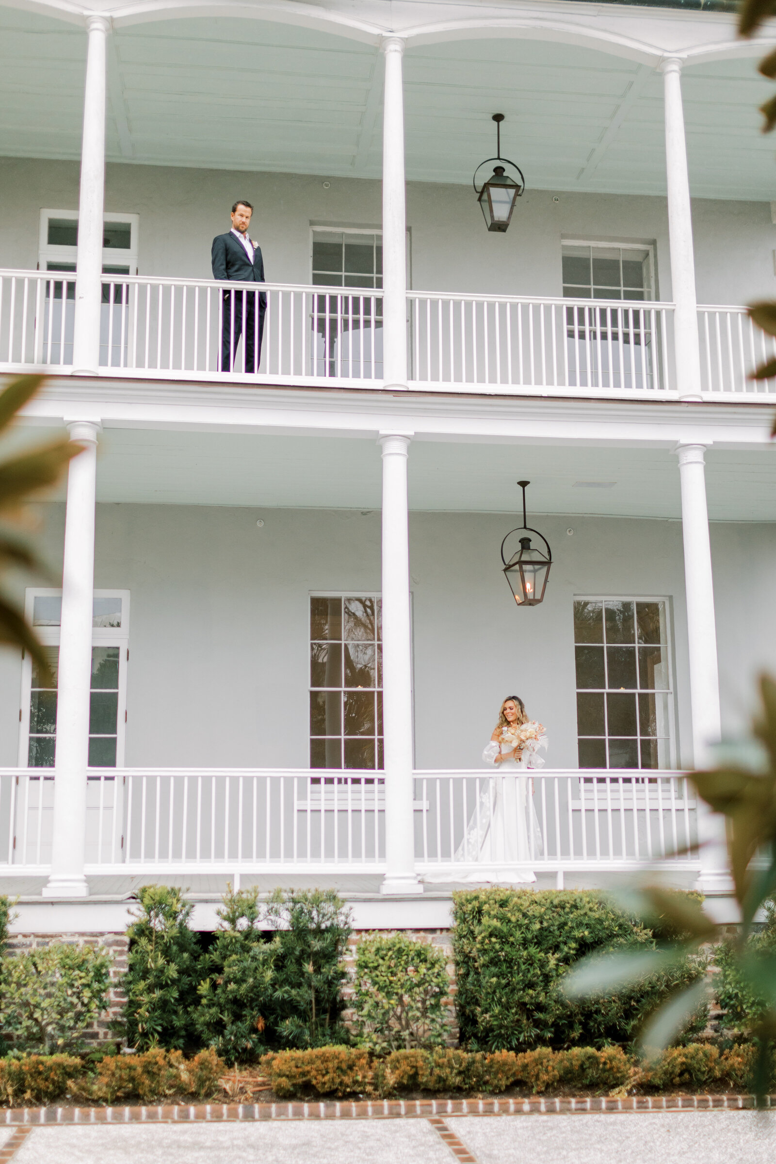 bride on lower level of the patio and groom on the upper level of the patio at the gadsden house in charleston south carolina