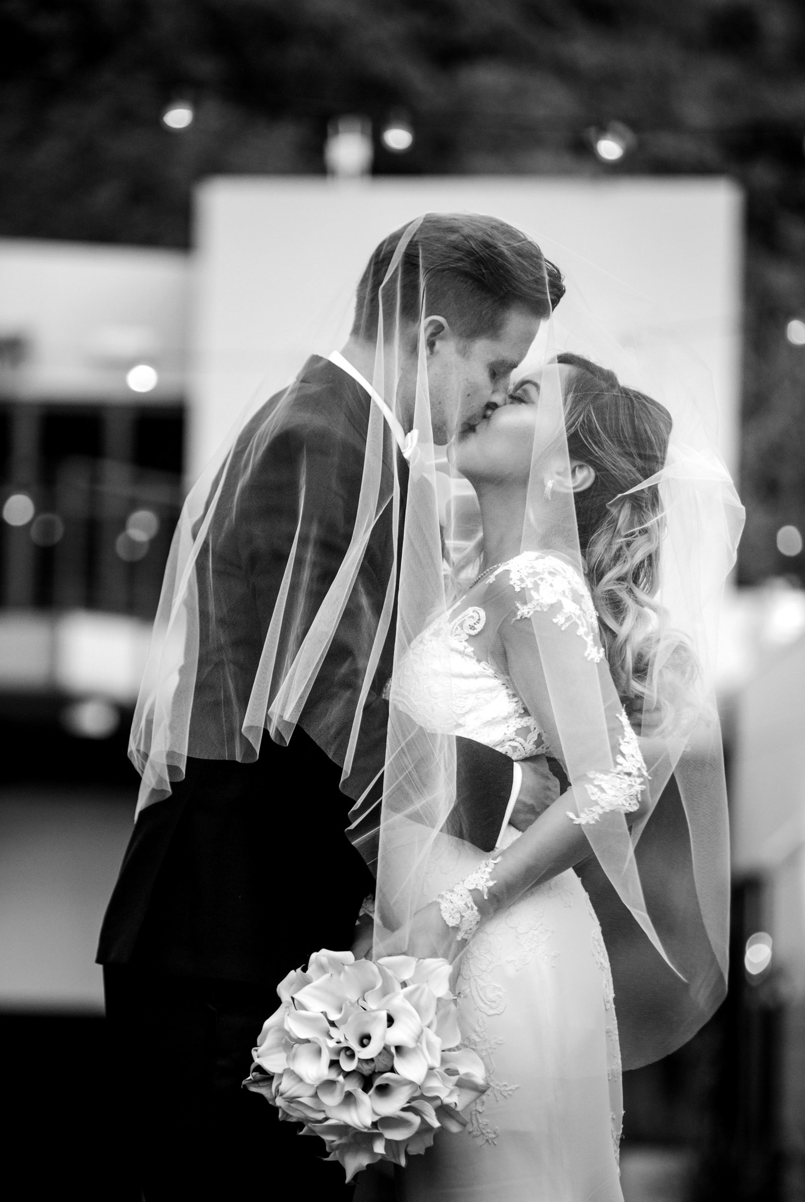 black and white photo of bride and groom kissing  in laguna beach seven degrees wedding