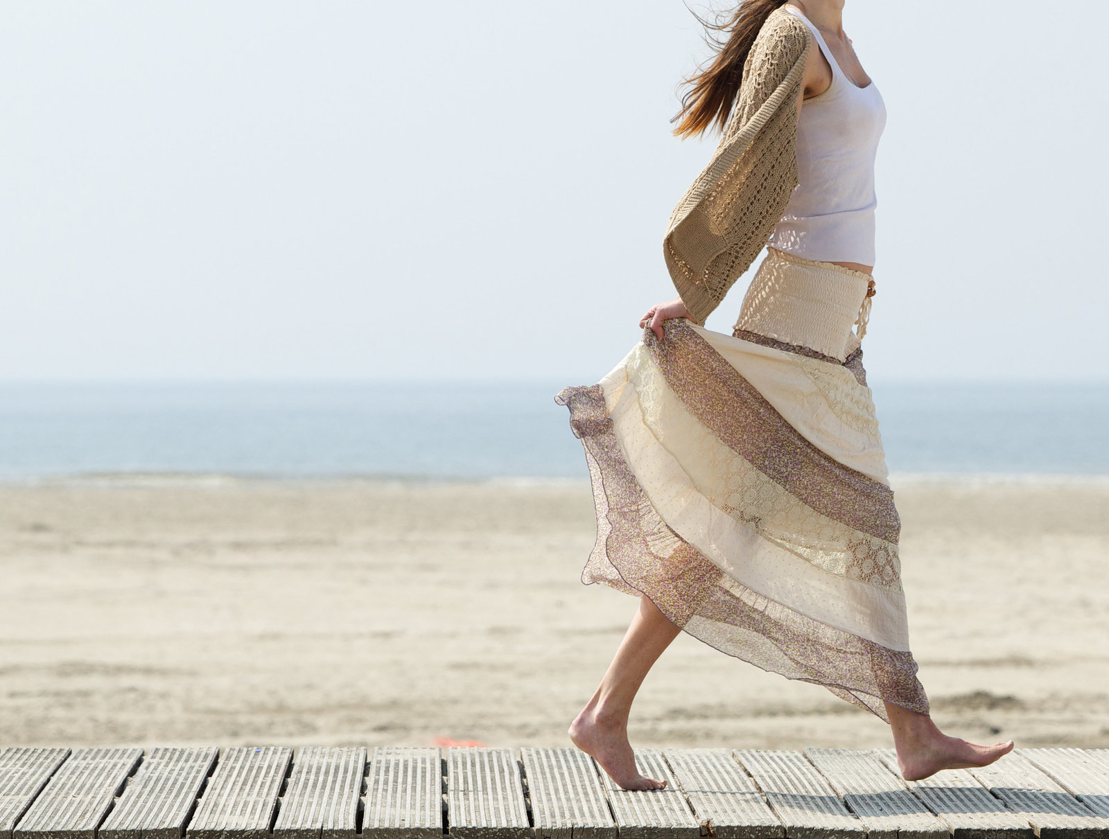 female-walking-at-the-beach-barefoot-with-dress-PJD4RW6