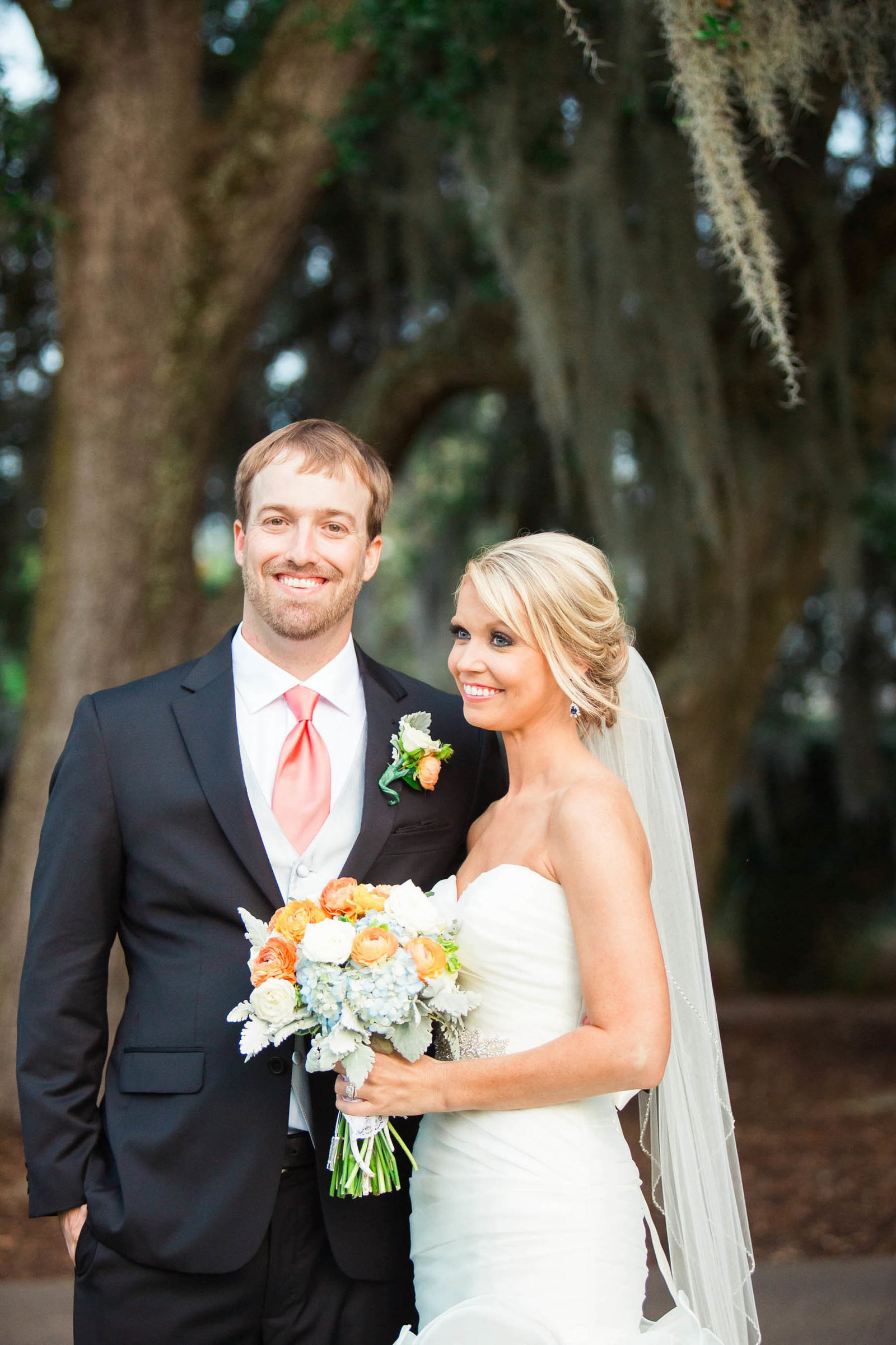 Bride and groom smile under oak trees, Dunes West Golf and River Club, Mt Pleasant, South Carolina