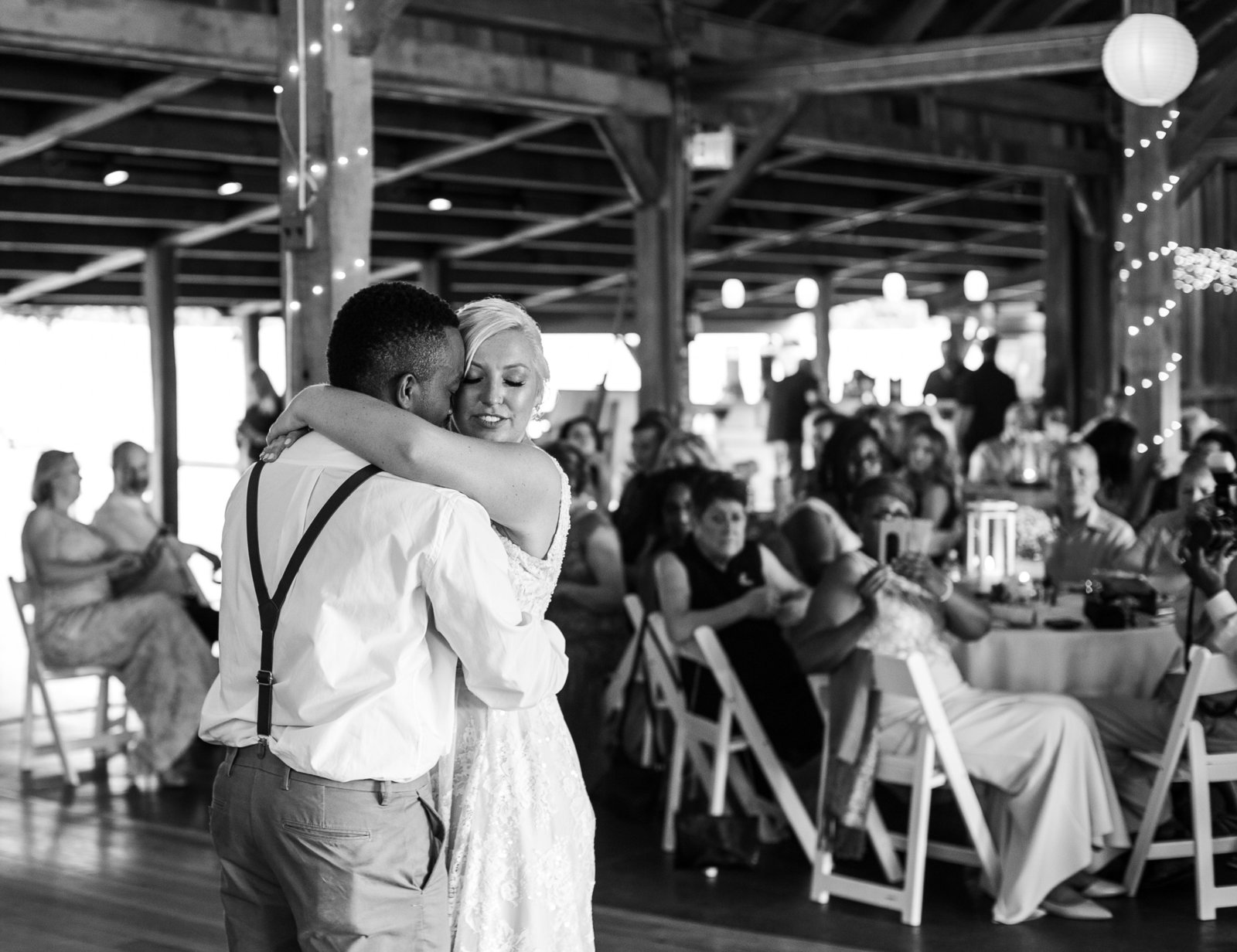 Bride and groom embrace during first dance at Betsy's Barn wedding