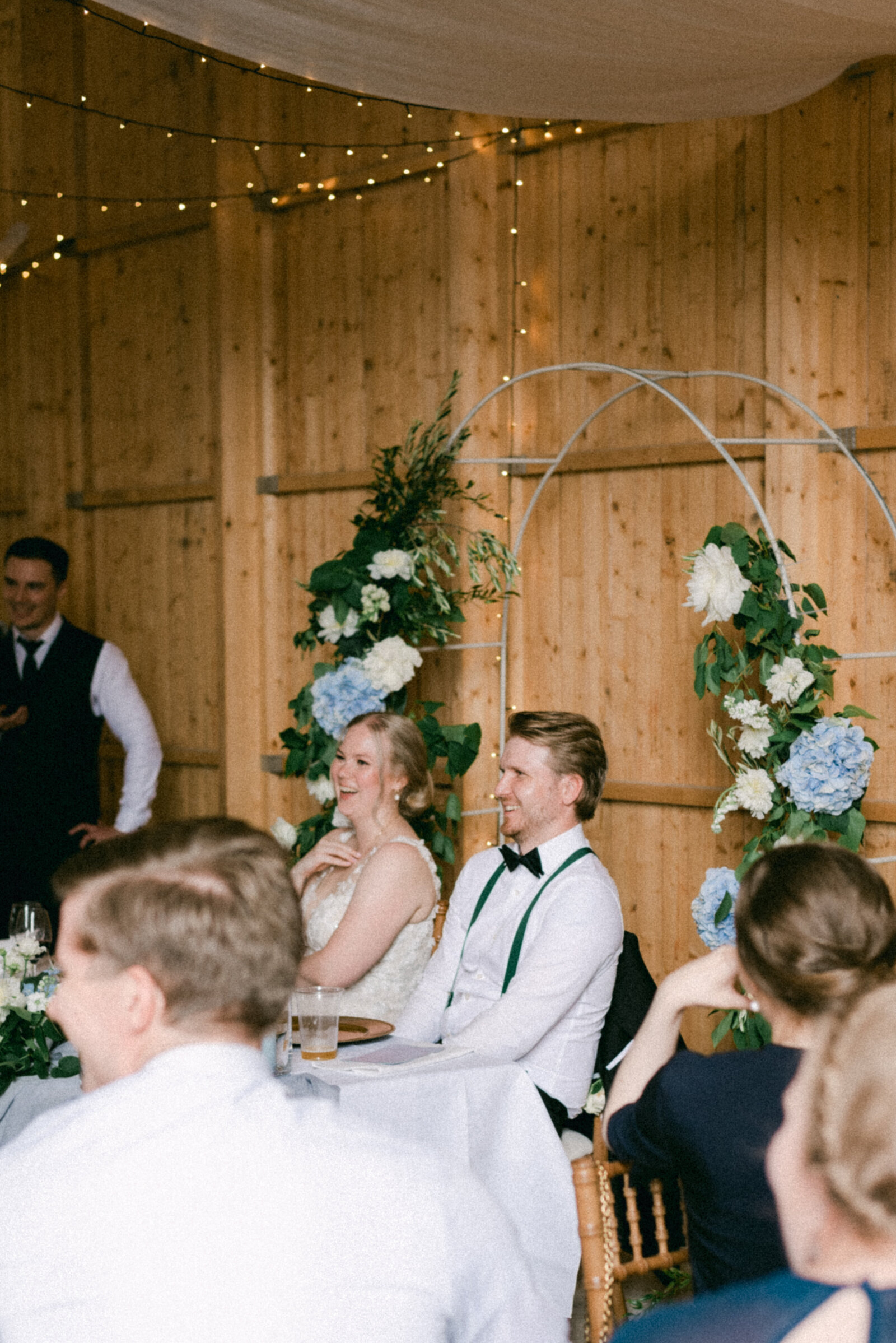 Wedding couple listening to a speechin an image photographed by wedding photographer Hannika Gabrielsson.