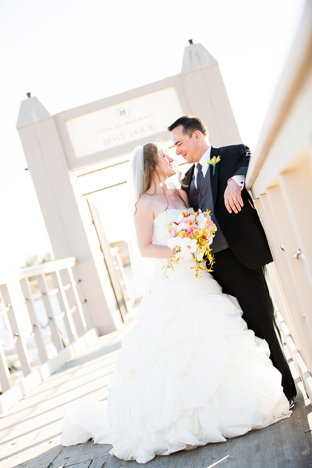 bride and groom on dock at hilton mission bay
