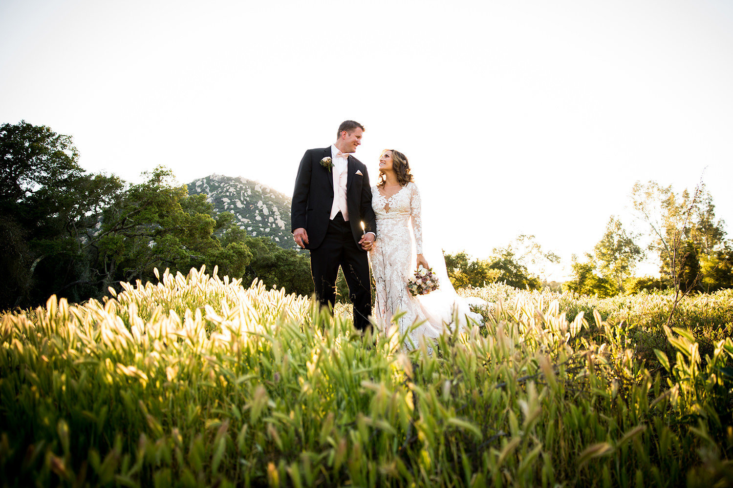 open field with bride and groom