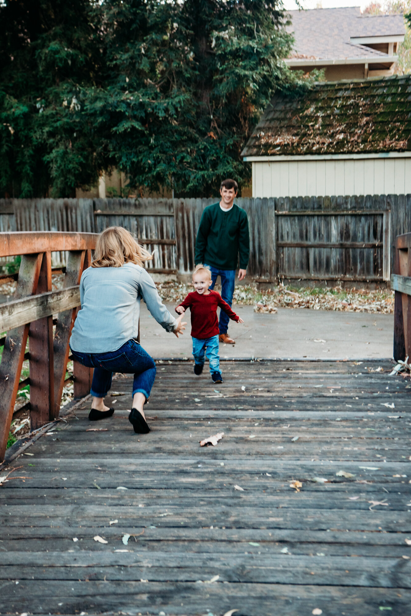 Lifestyle family photos where toddler is running to mom's open arms.