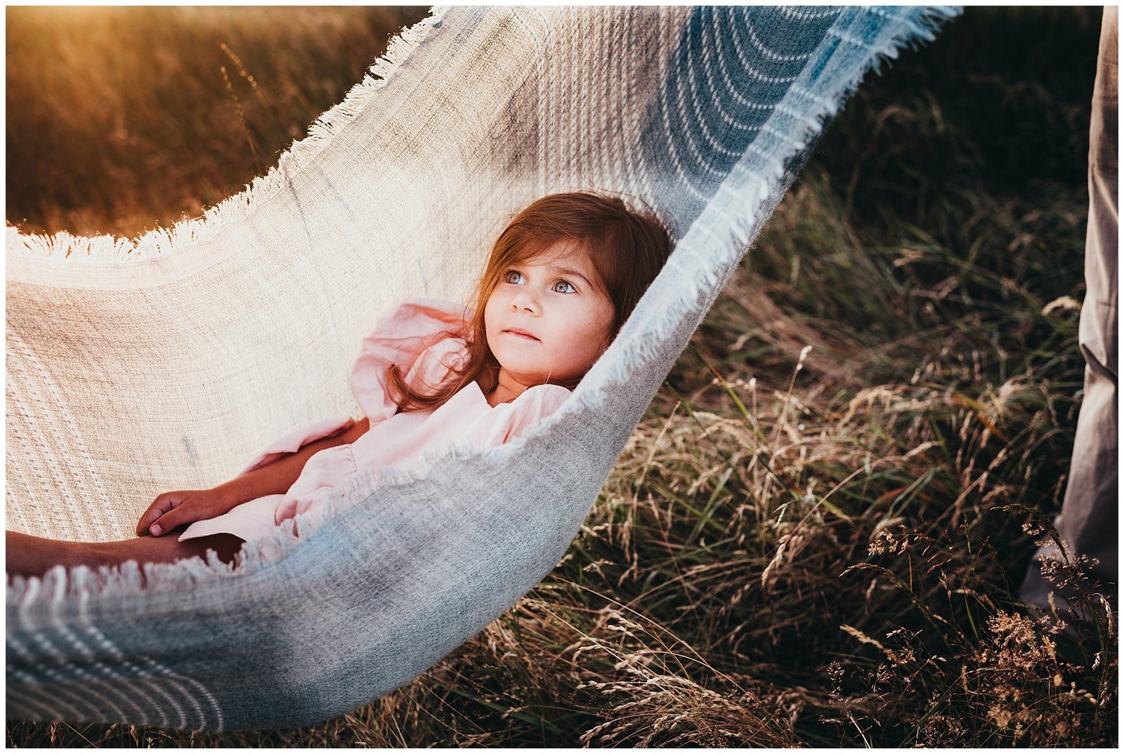 Little girl swining in blanket in field at sunset Emily Ann Photography Seattle Photographer